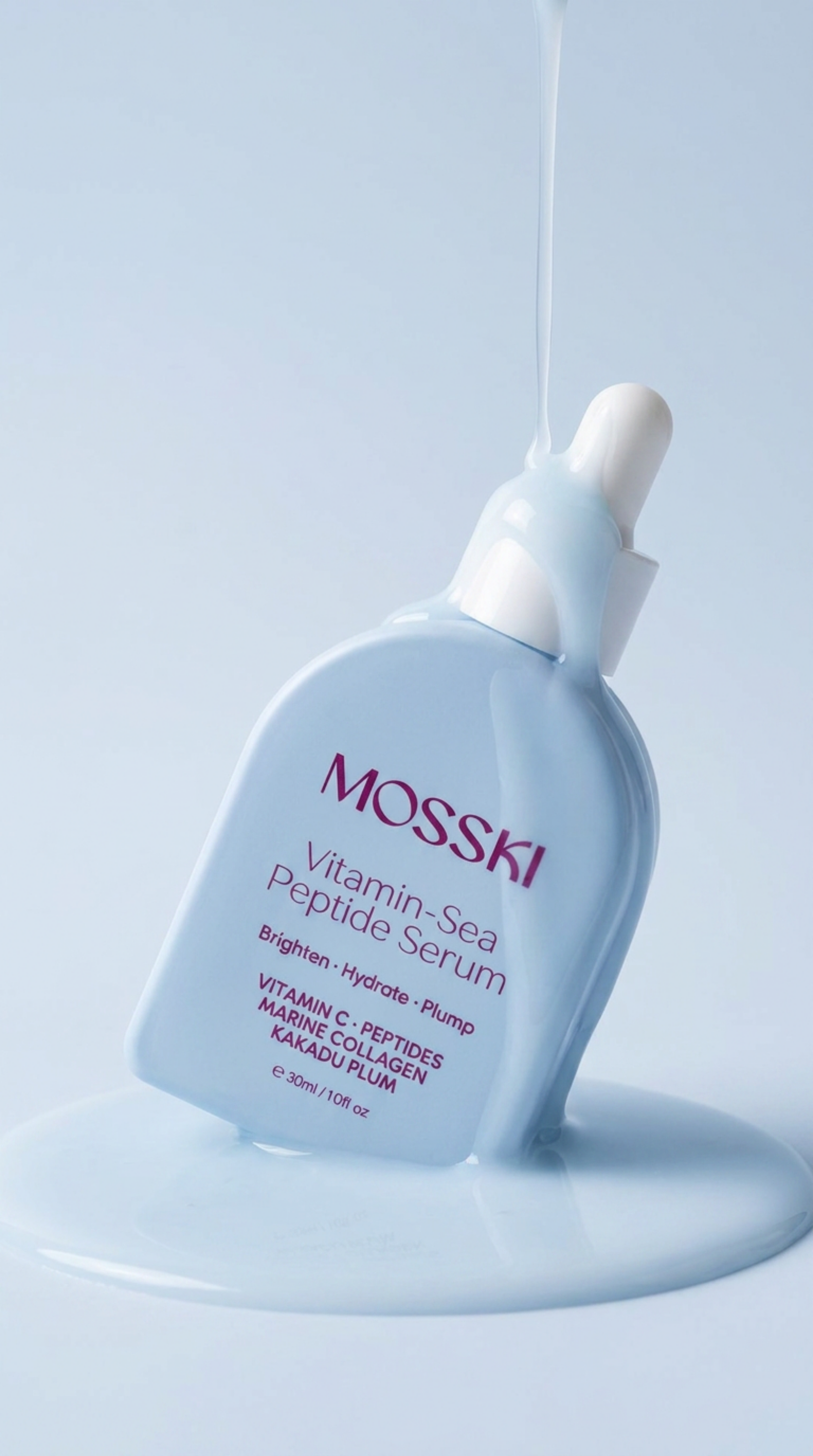 Close-up of a Mosski Vitamin Sea Peptide Serum bottle with serum spilling, showing product name and ingredients on the label.