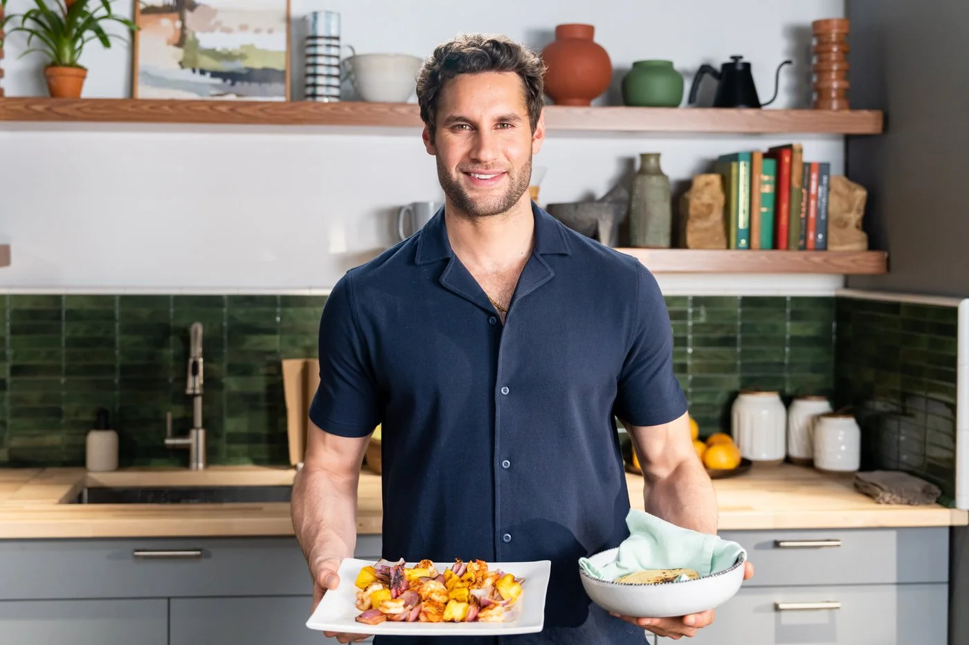 Host Franco Noriega poses with his Grilled Shrimp Tacos dish.jpg