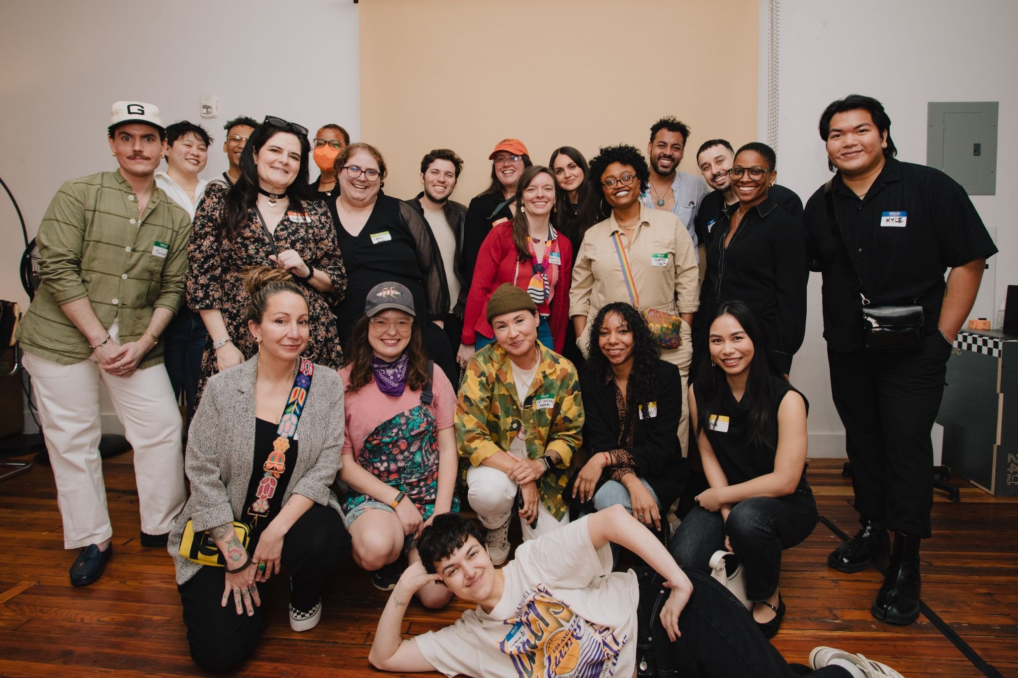 Group photo of LGBTQ+ business owners and professionals with name tags posing for a photo.