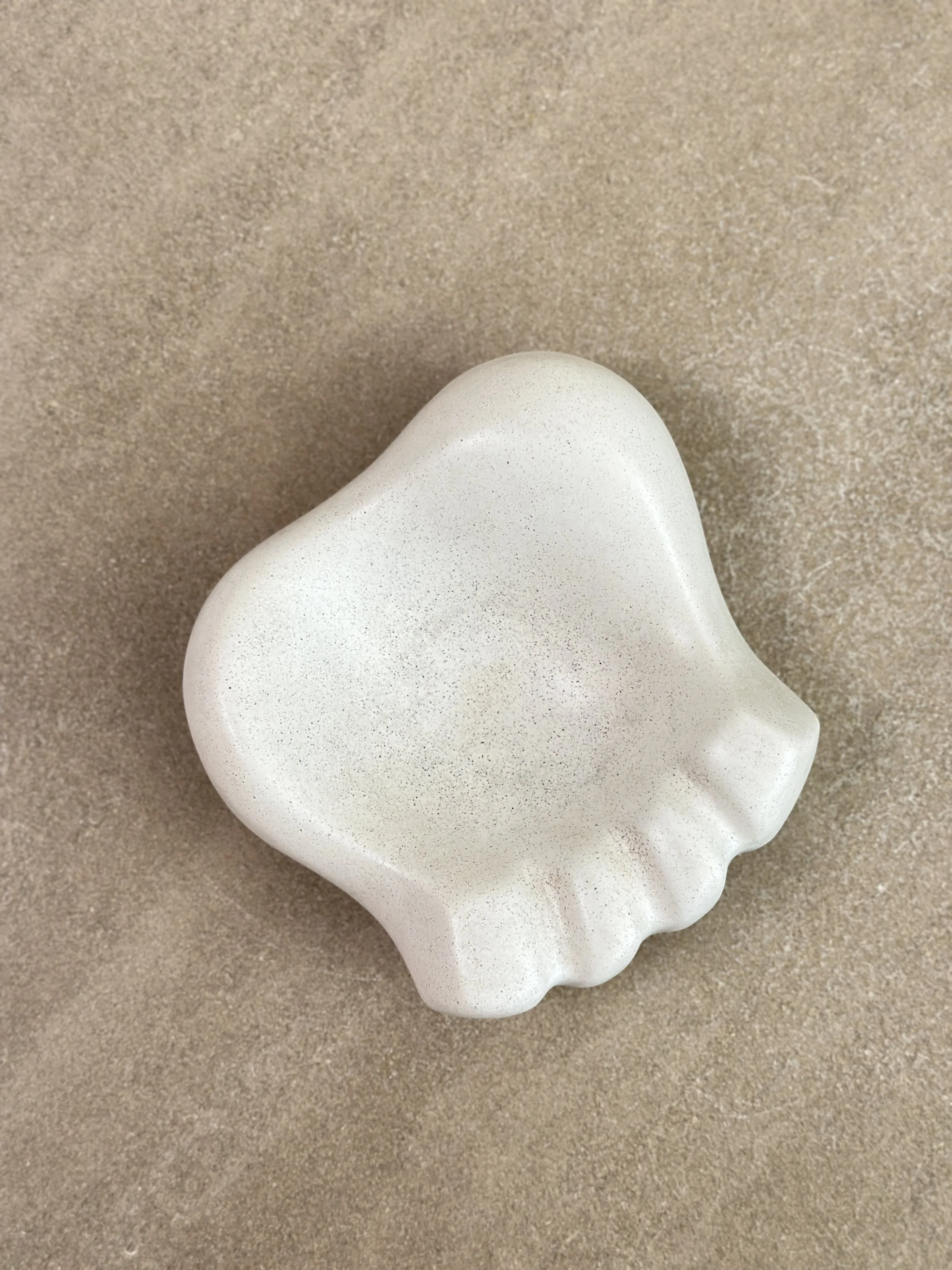 Georges Jouve 'Patte d’Ours' ashtray on a Mathieu Matégot black lacquered metal stand.