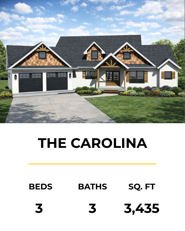 Front view of a two-story suburban house with a dark gray roof, white siding, and black window shutters, surrounded by a well-maintained lawn and landscaping.