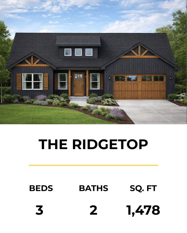 Front view of a two-story modern house with black siding, wooden accents, and a two-car garage, surrounded by a landscaped lawn with bushes and flowers, under a partly cloudy sky.