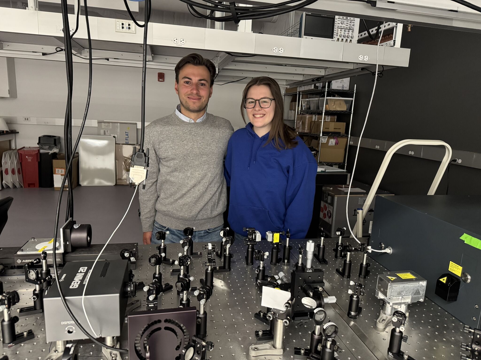 May 2026: Manu successfully finishes his internship and heads back to Belgium! Here's a photo of him and his mentor, Becca, taken in our laser lab.