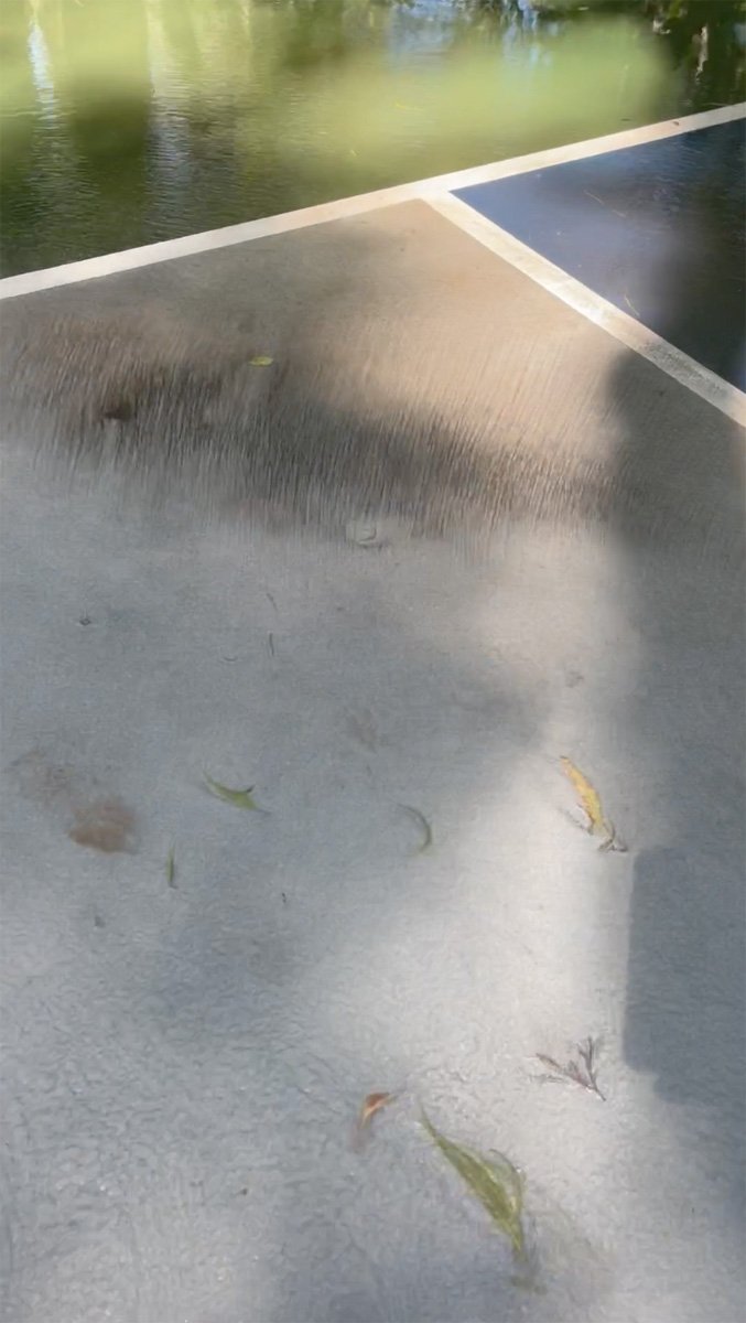 Surface dirt being removed with water broom