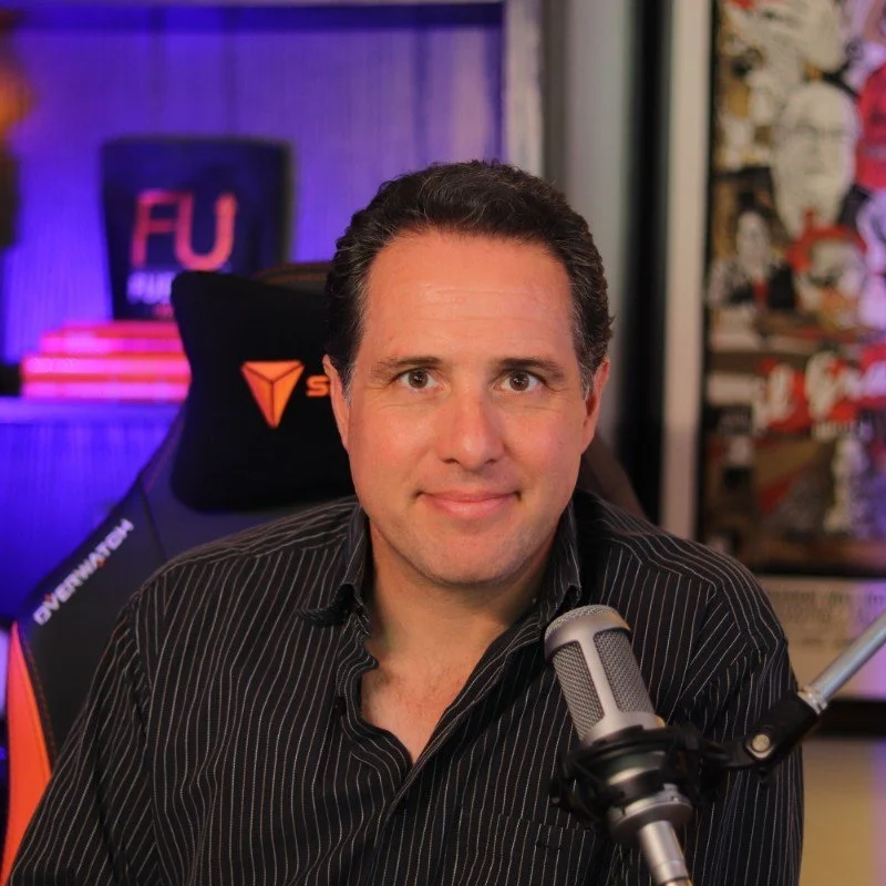 headshot of man at microphone