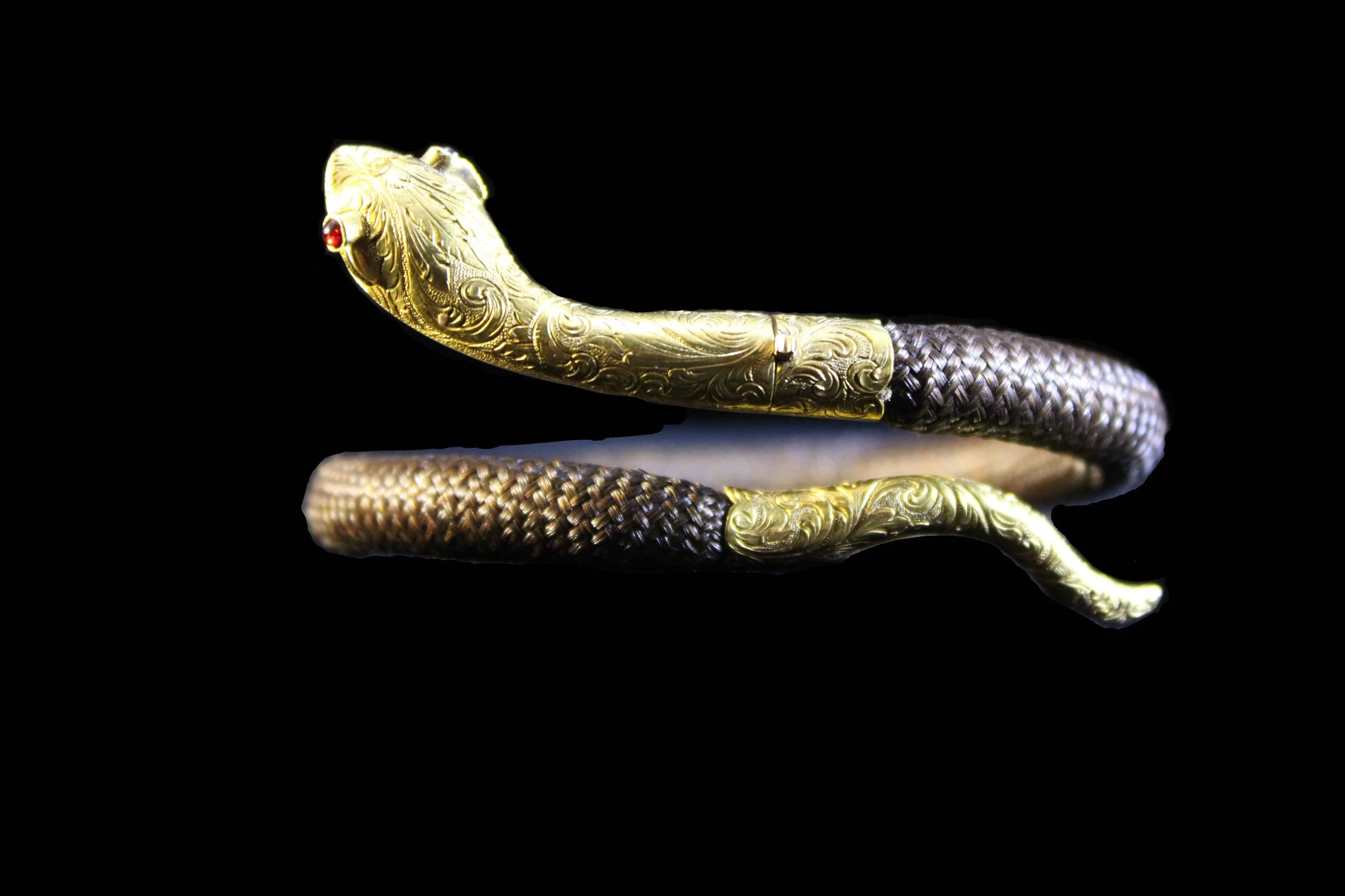 Angled view of Victorian hairwork serpent bracelet emphasizing movement and symbolism