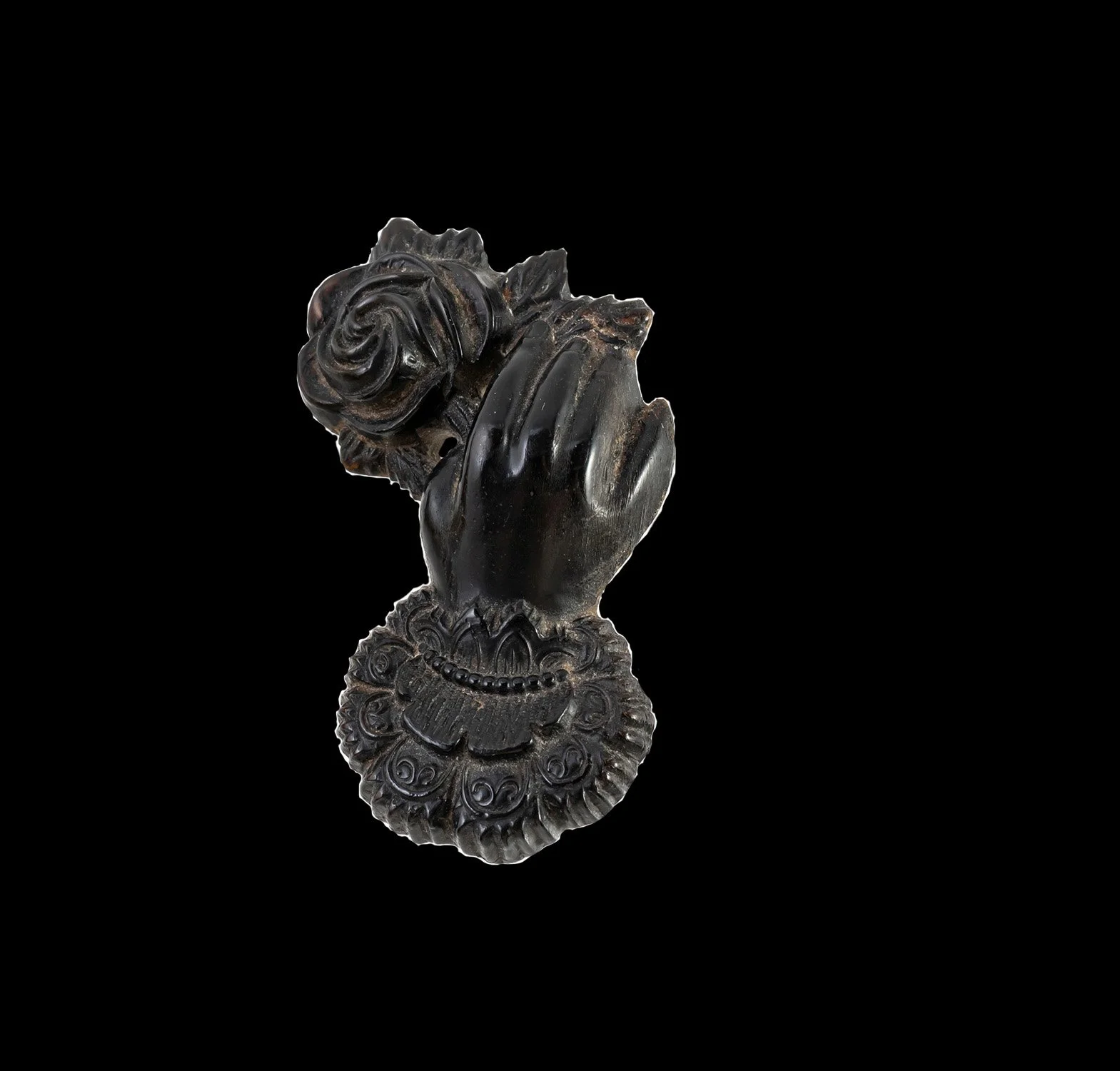 Victorian jet pendant carved as a hand holding a rose