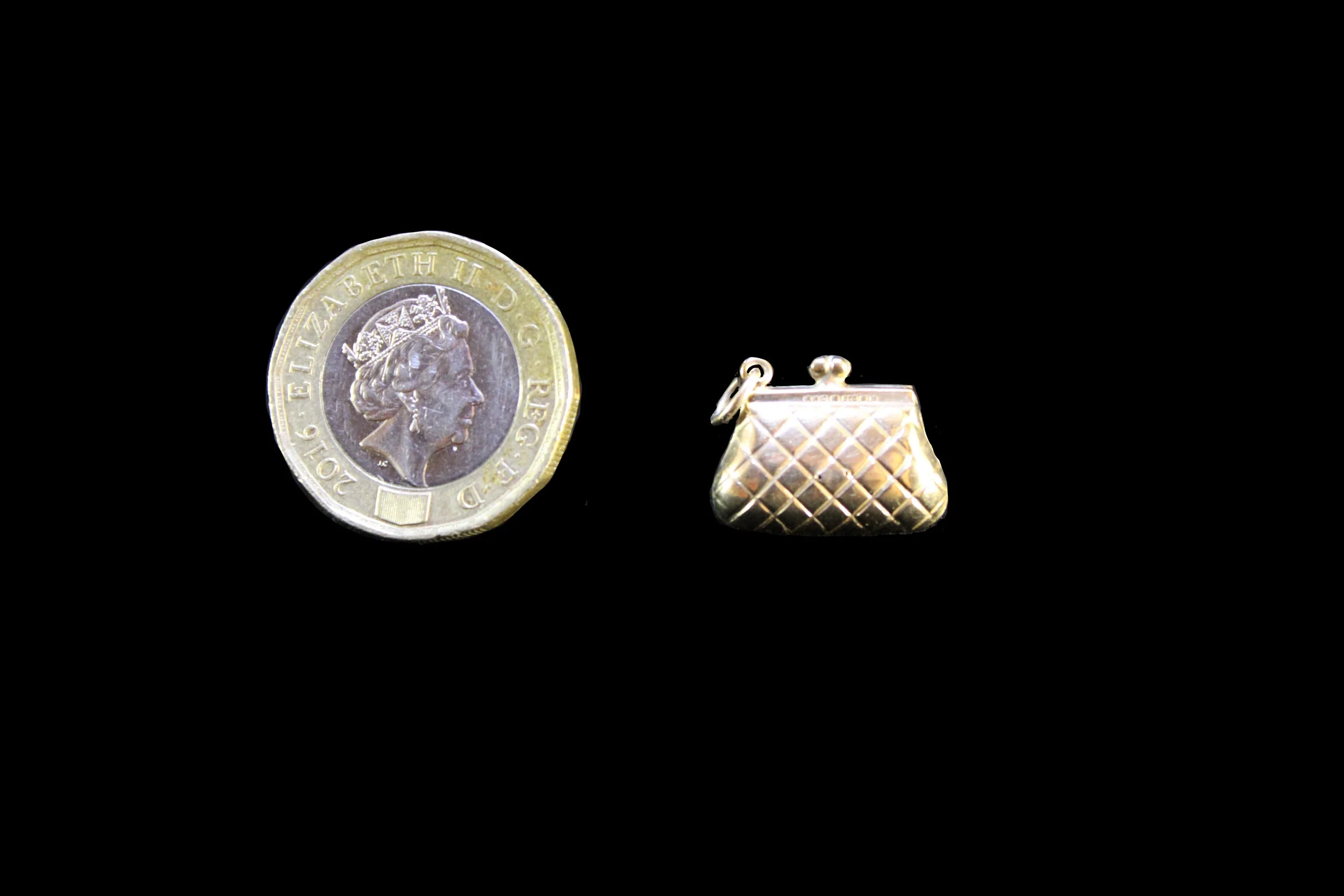 Vintage handbag charm shown beside coin for scale