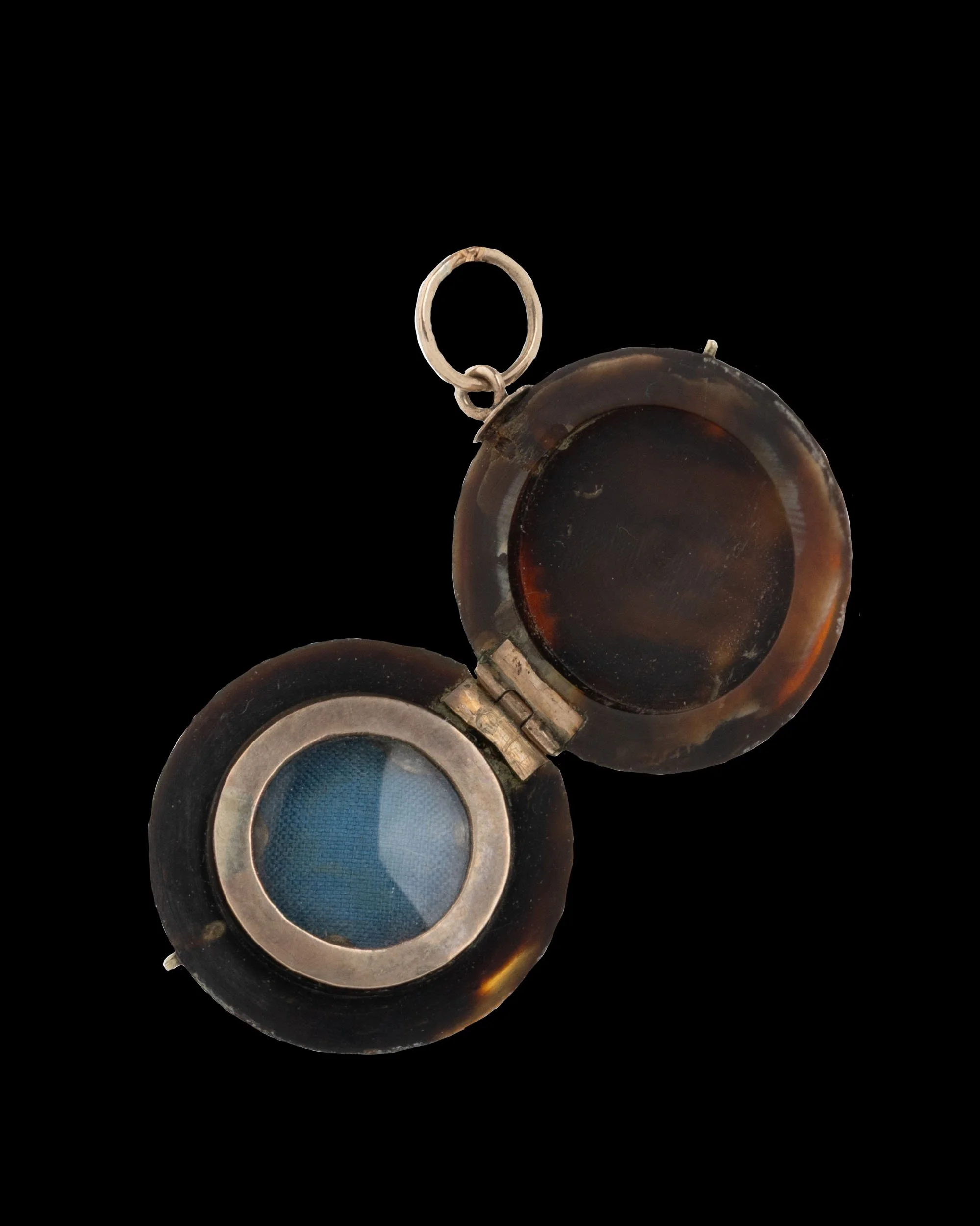 Victorian tortoiseshell locket opened to reveal original interior compartment with 9K gold rim