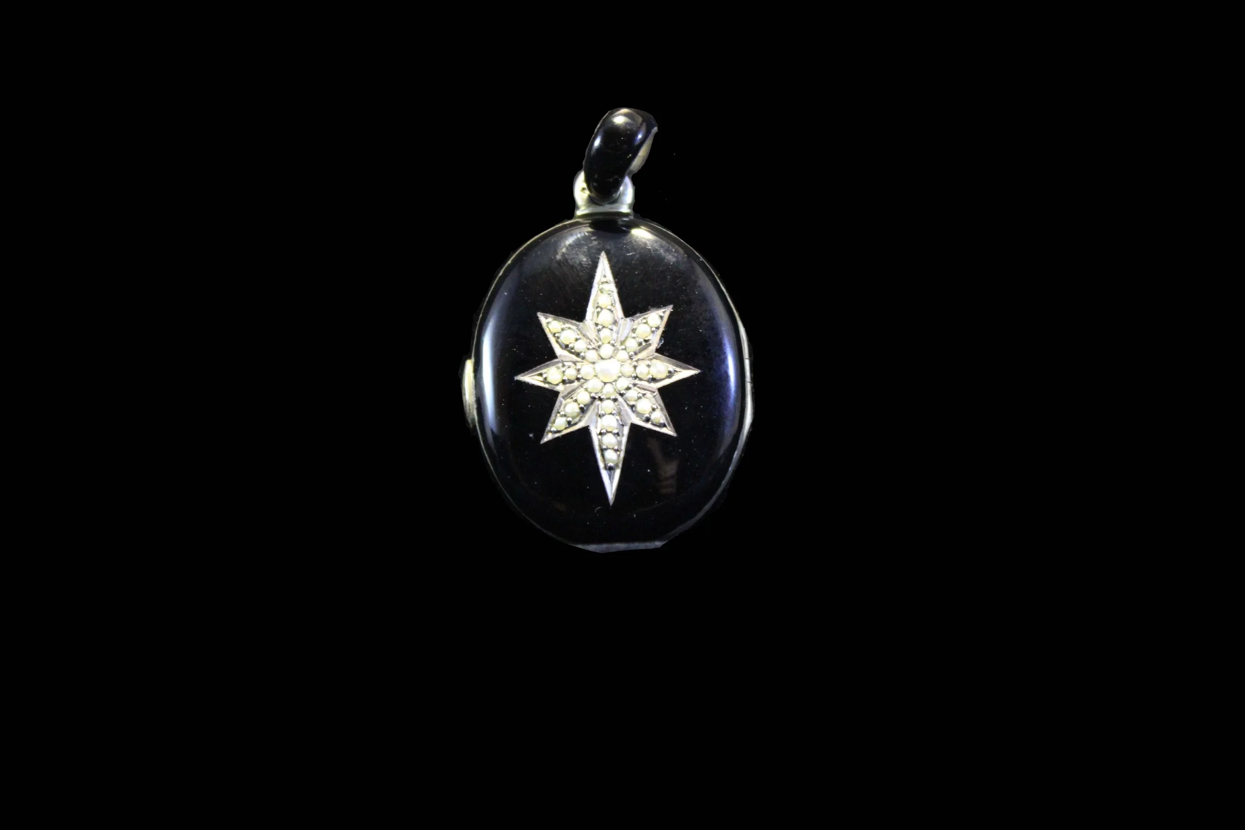 Victorian black enamel oval locket set with seed pearl eight-point starburst, antique mourning jewelry