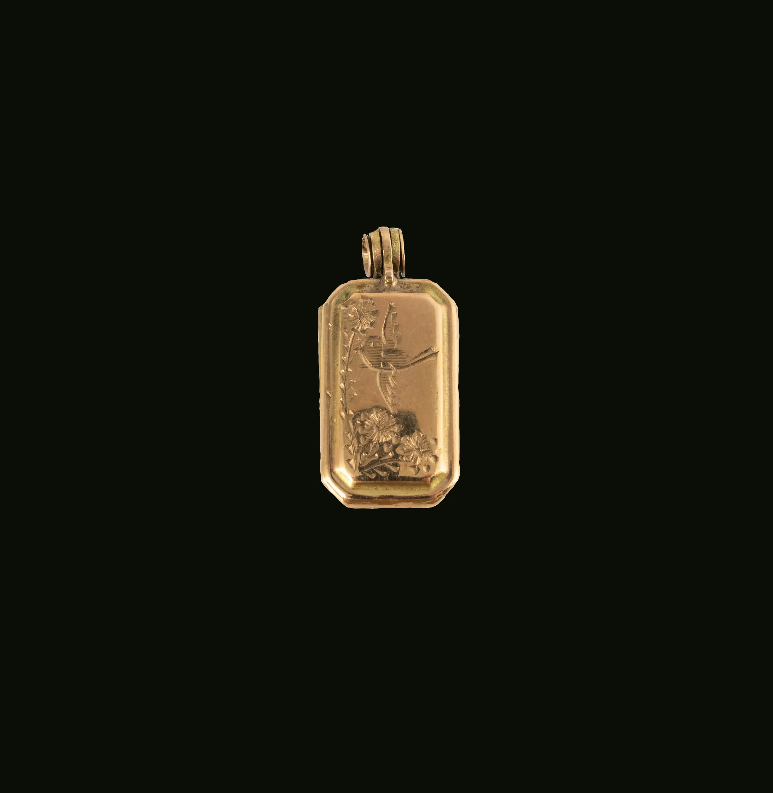 Victorian 9K gold rectangular locket with engraved bird and floral motif on black background