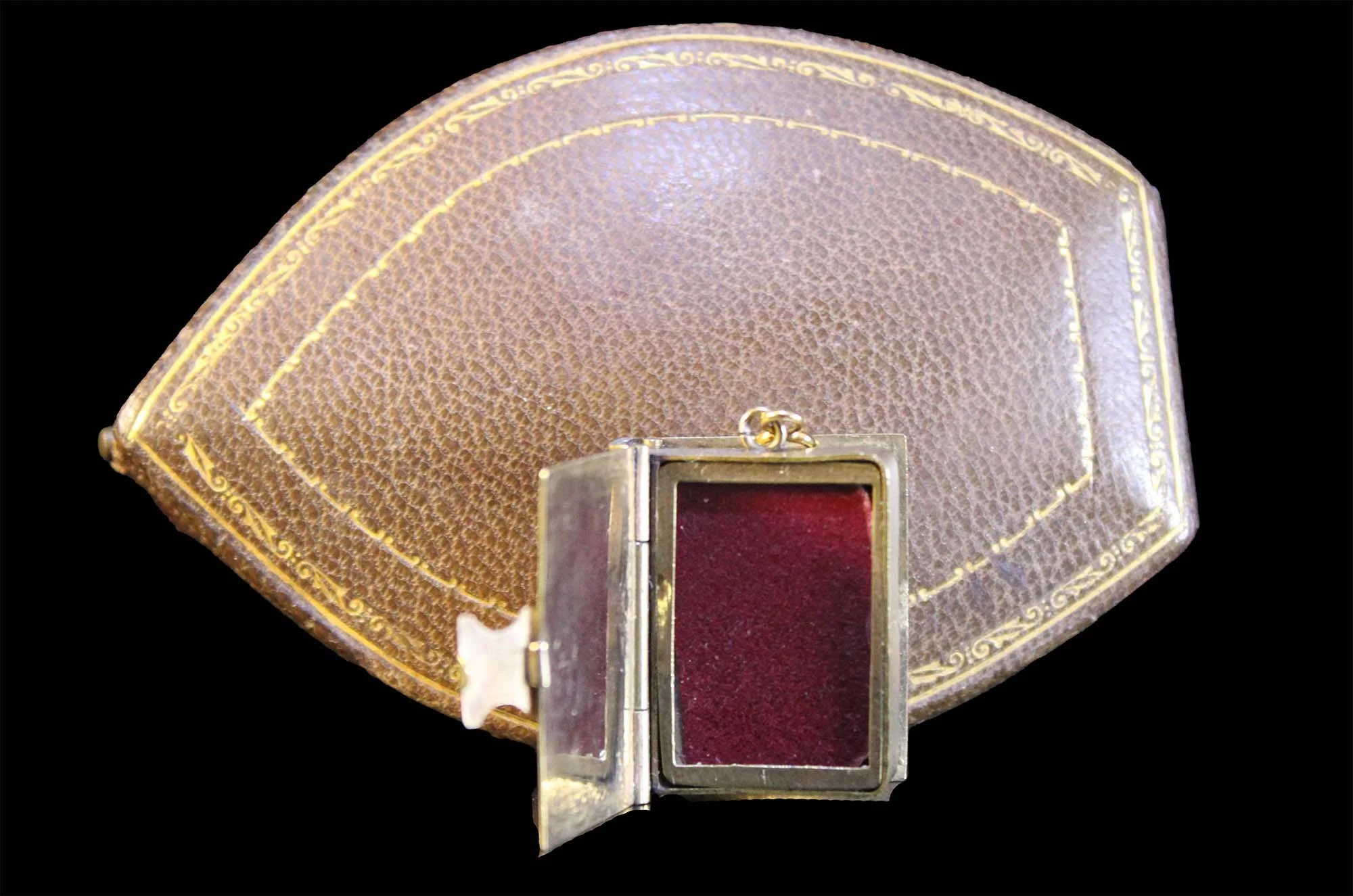 Front open view of locket showing crimson lining and Victorian presentation case.