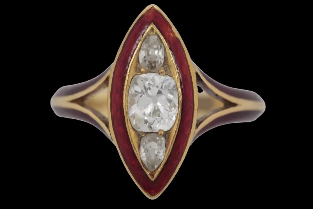Front view of Victorian 1874 mourning ring with a central cushion-cut diamond, two pear-shaped diamonds, and crimson enamel navette border.