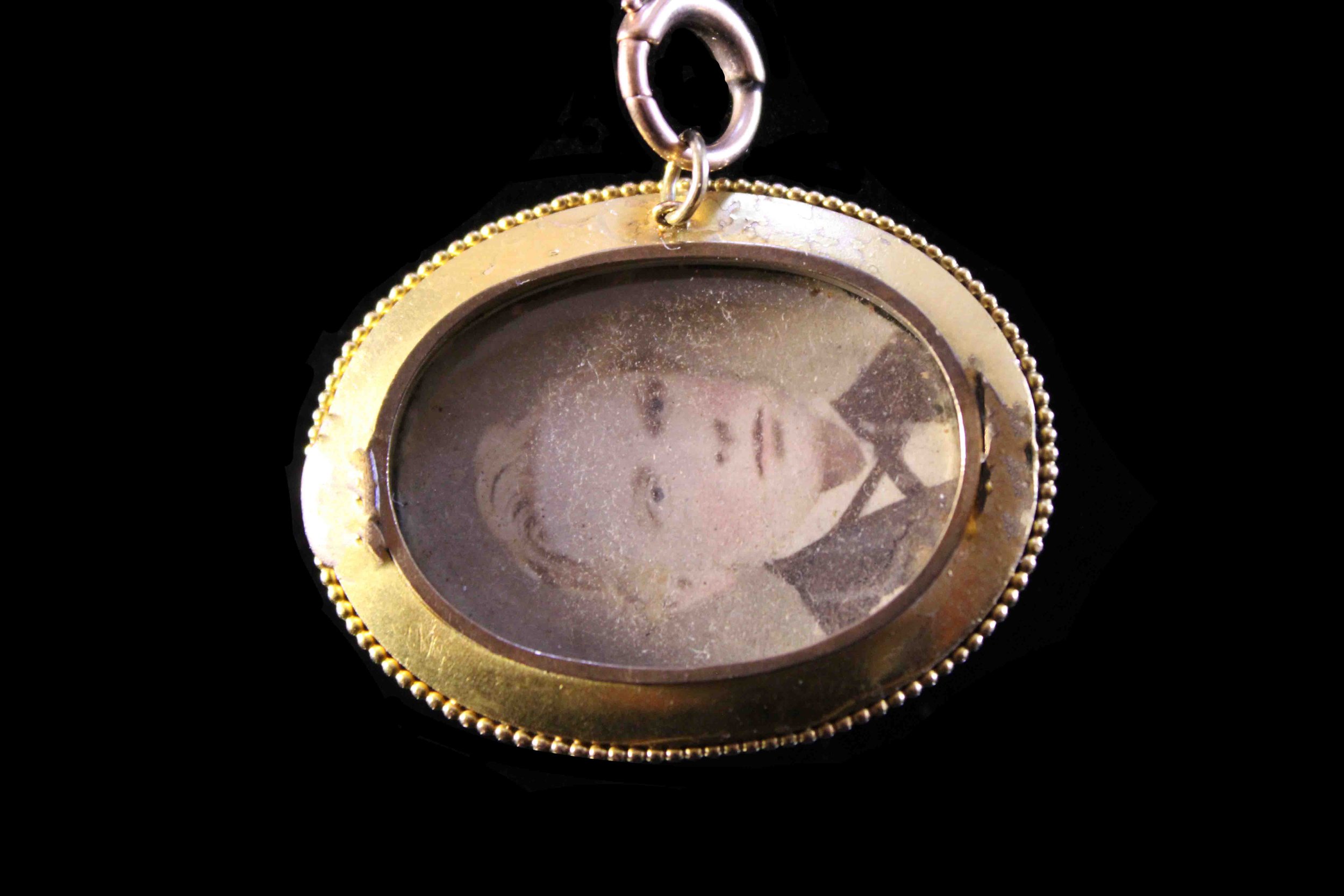 Reverse of Victorian mourning locket with original photographic portrait under glass