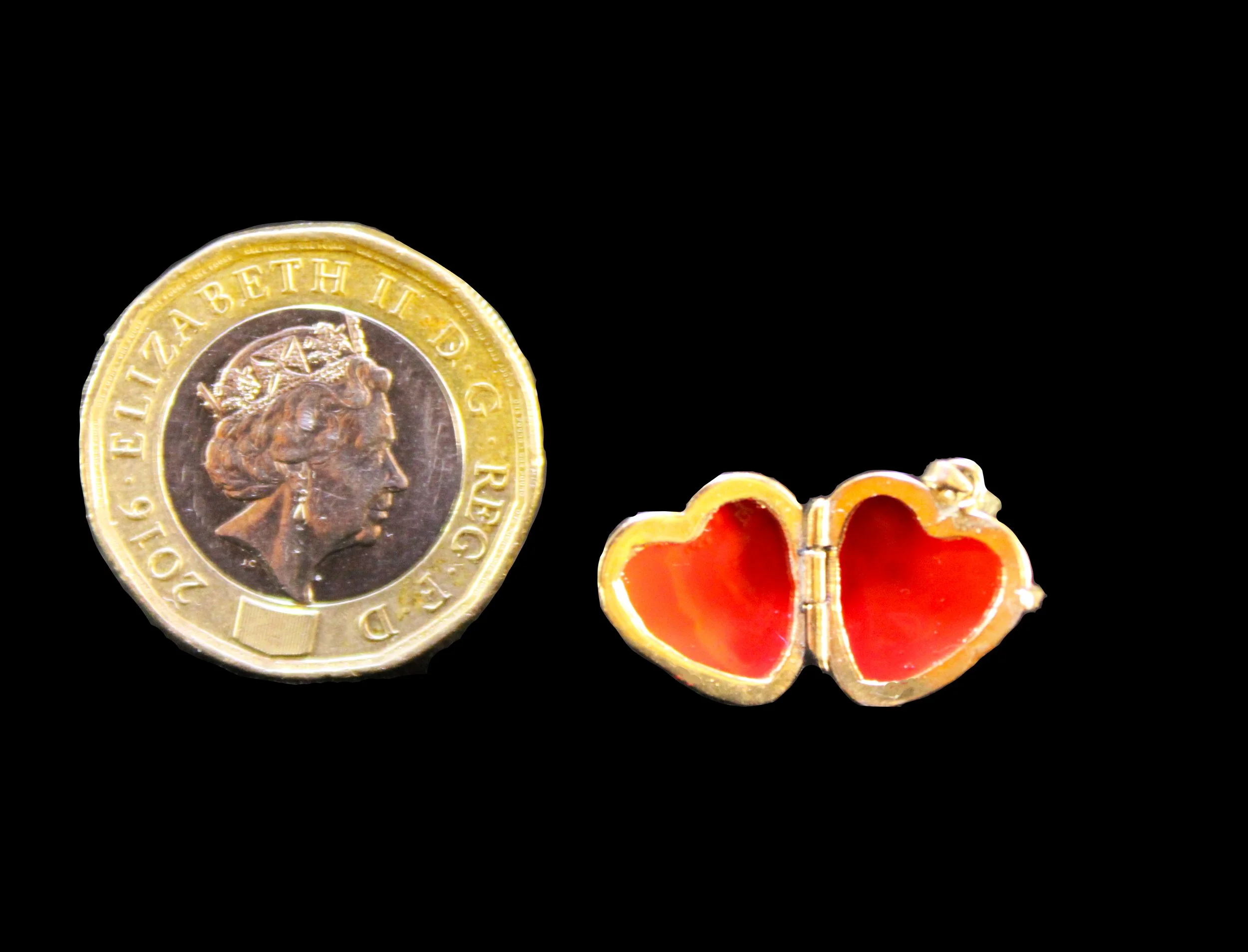 Antique sentimental heart locket open showing red enamel panels