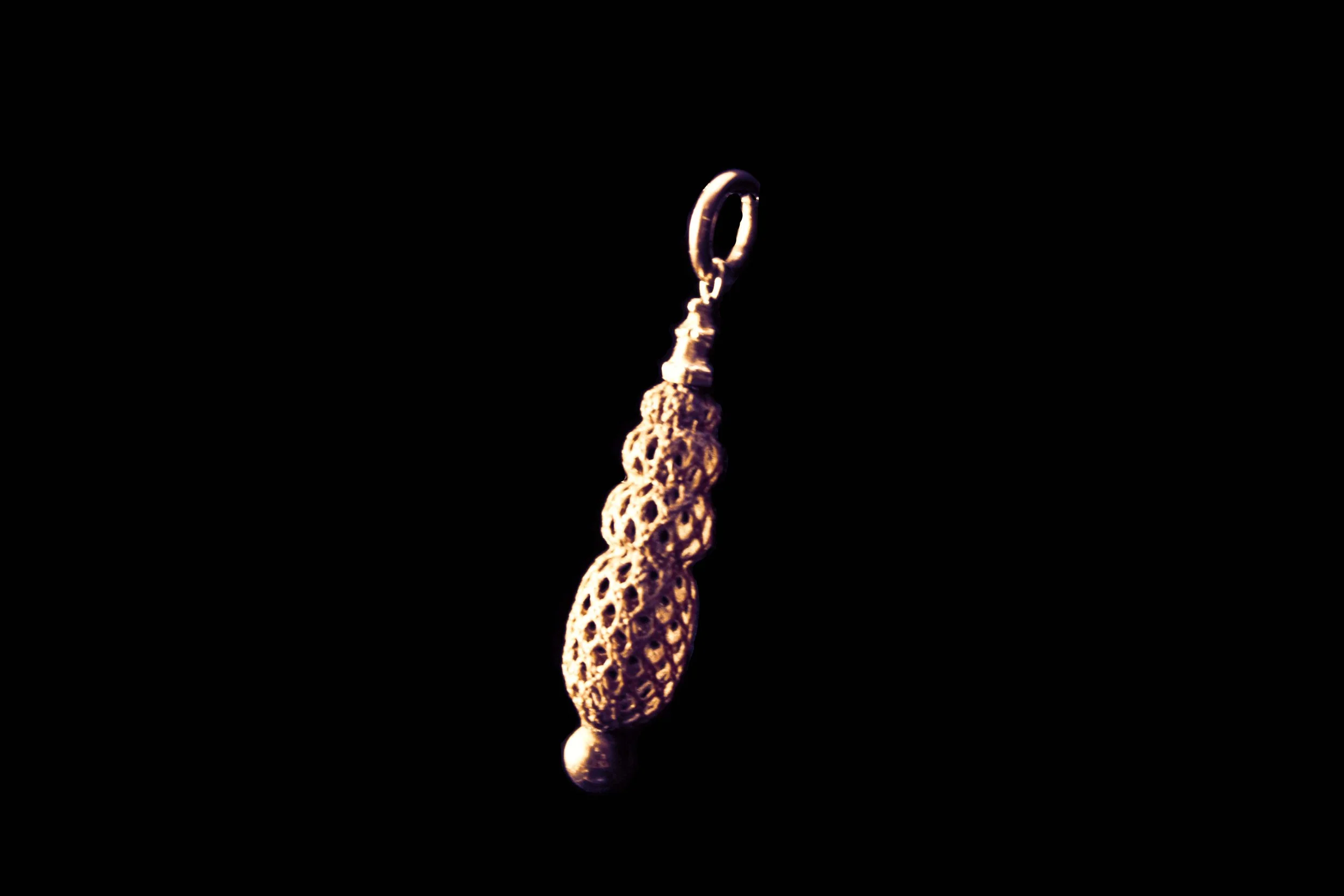 Detail view of woven hairwork and gold terminal on Victorian pendant