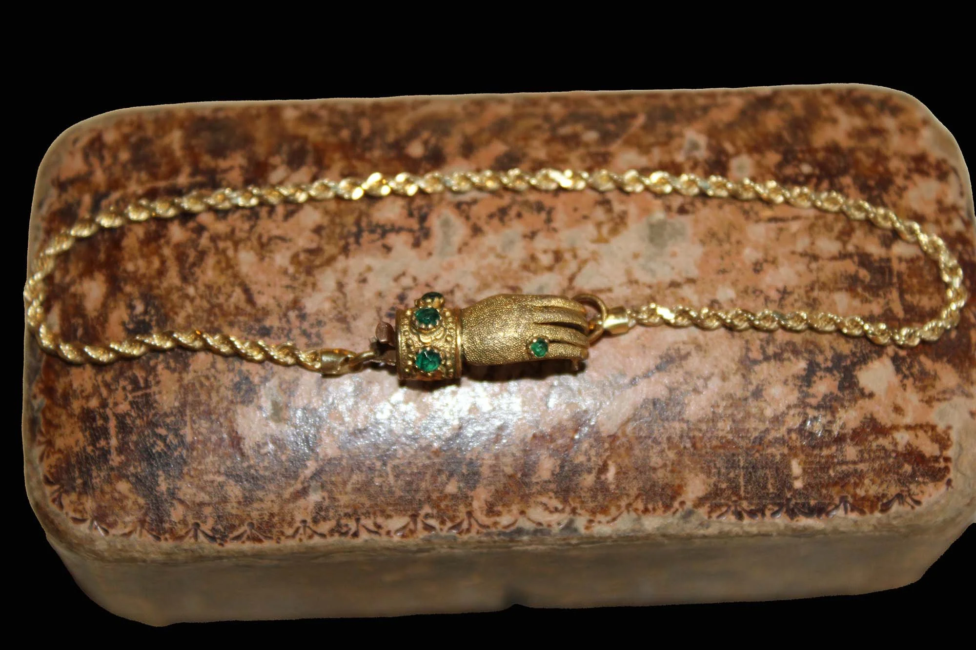 Victorian antique hand clasp bracelet displayed across a presentation box showing rope twist chain.