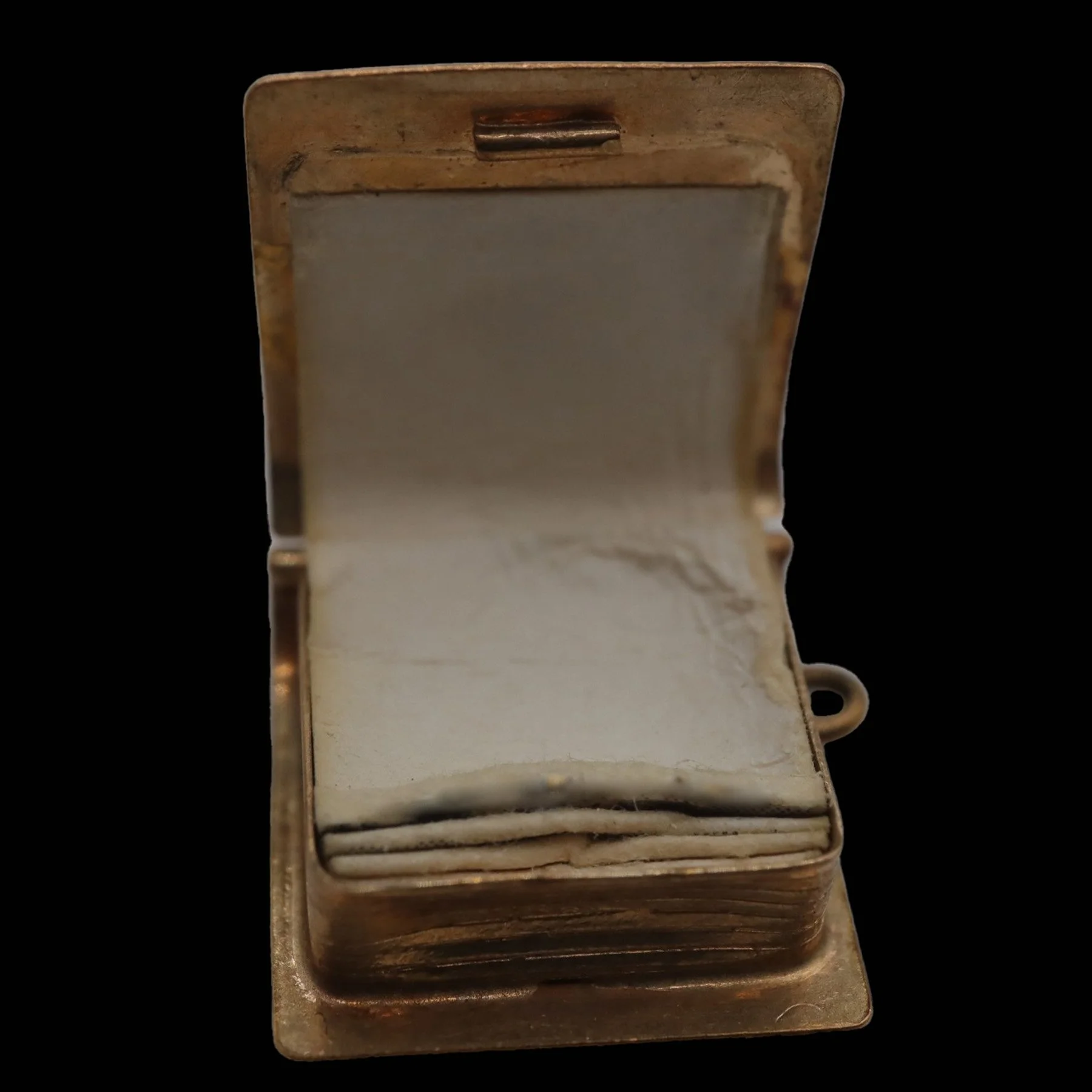 Open miniature gold book pendant revealing original paper inserts