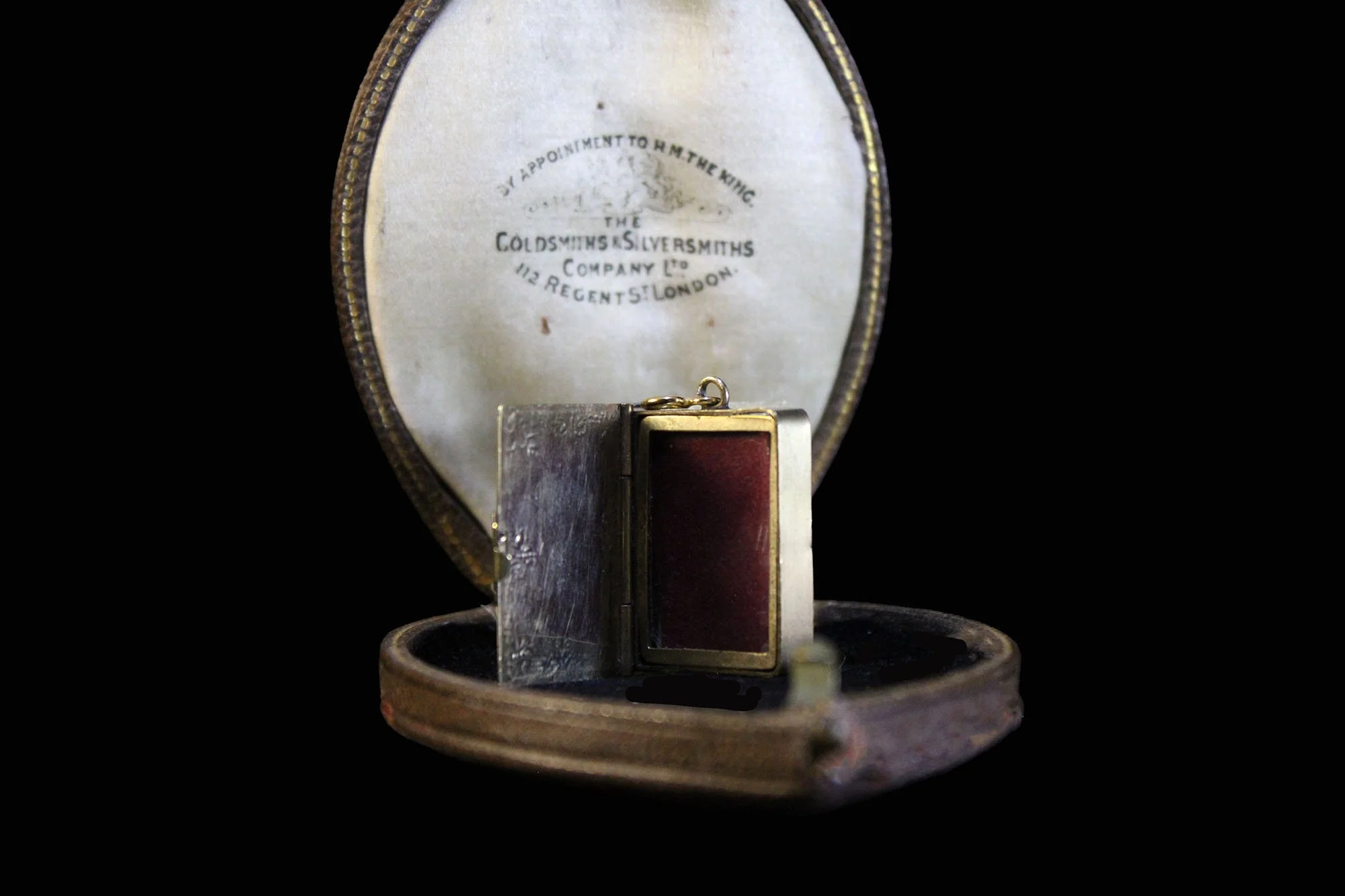 Front open view of locket nestled in its Victorian case