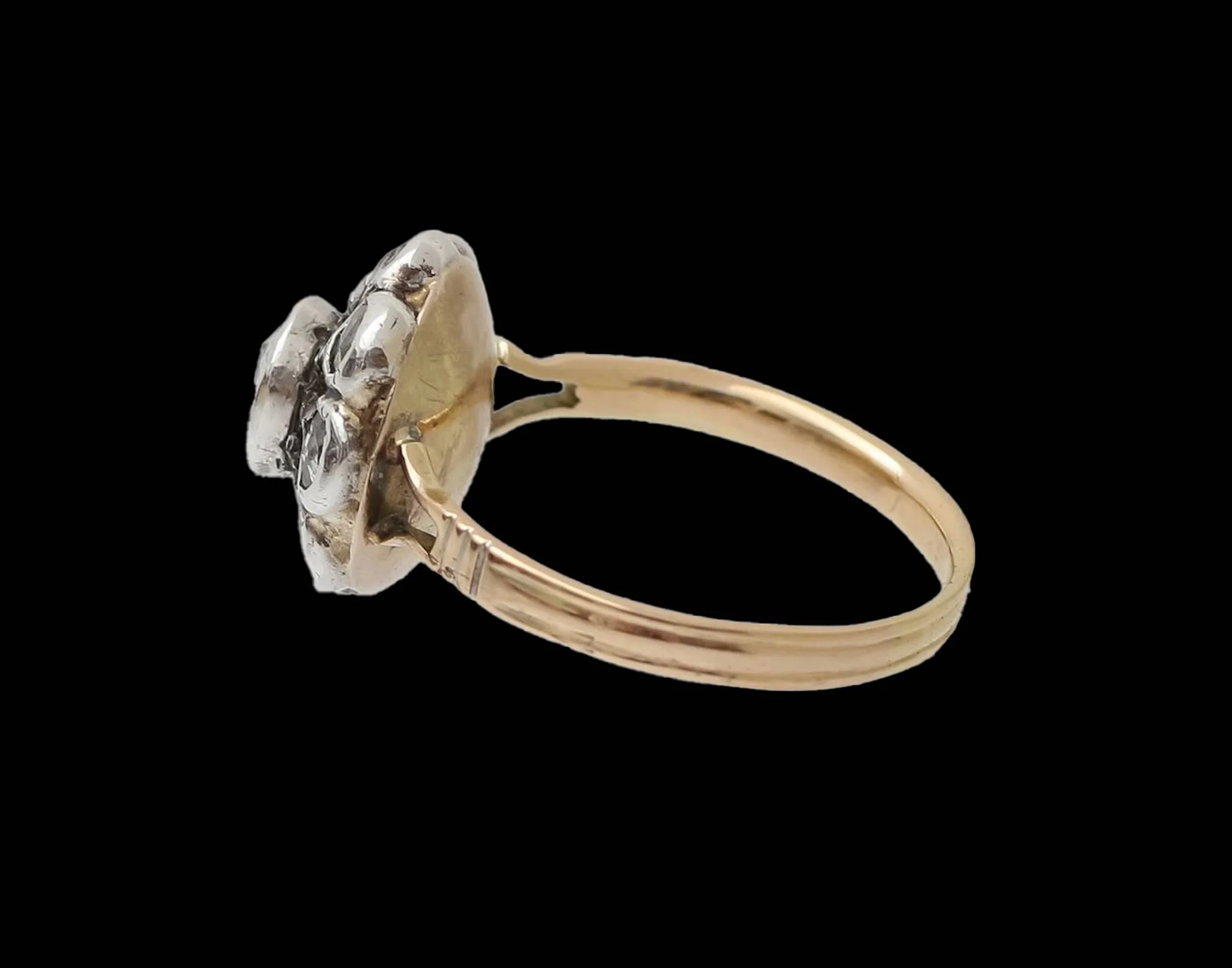Side view of Victorian 18ct gold and silver diamond cluster ring showing closed-back setting and open shoulders