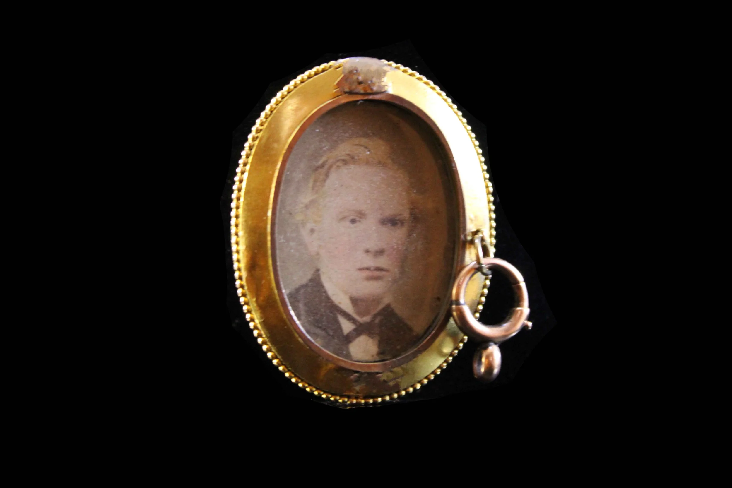 view of Victorian enamel locket highlighting original photograph and bezel