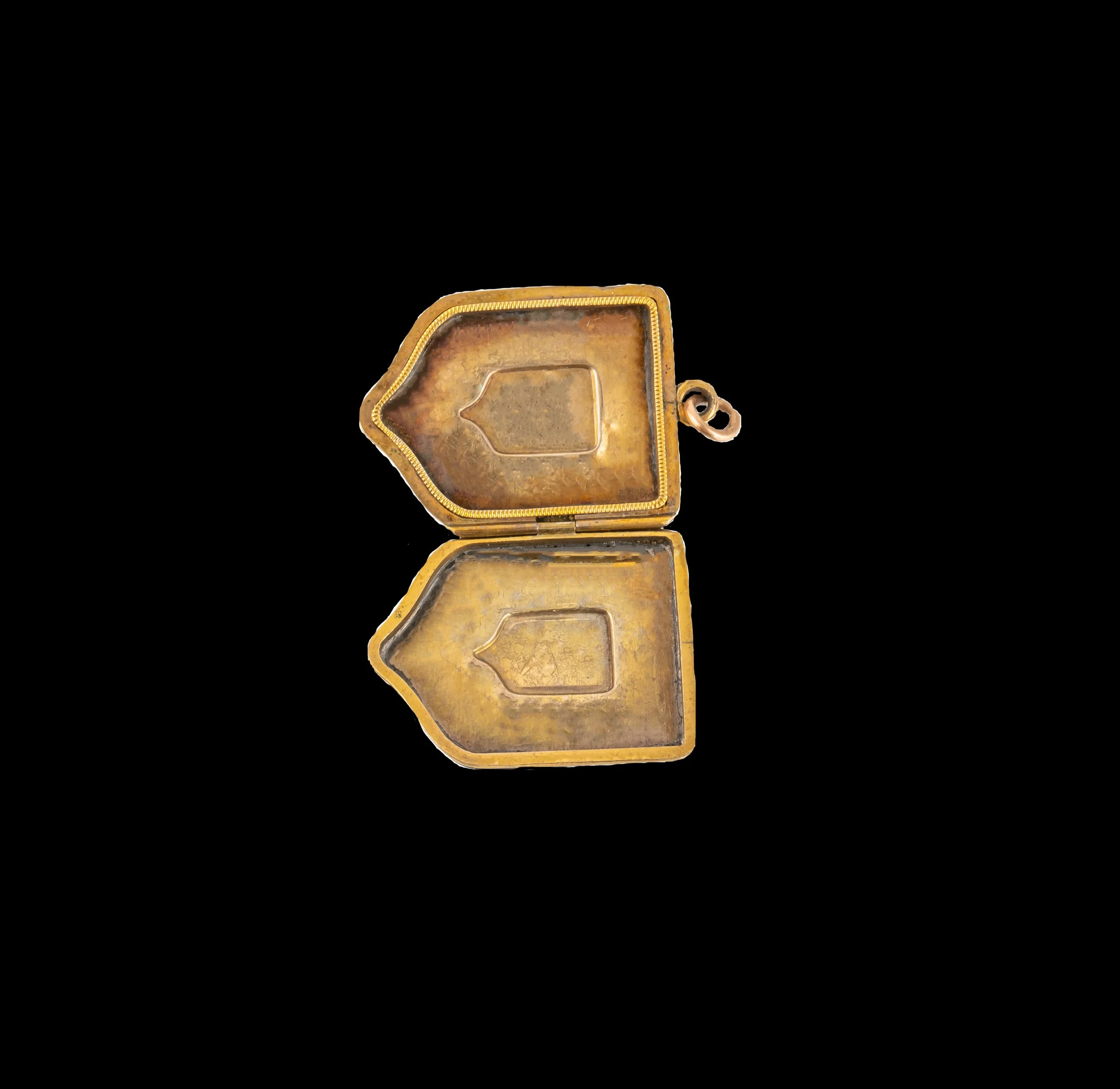 Open Victorian shield locket showing original interior compartments and hinged construction