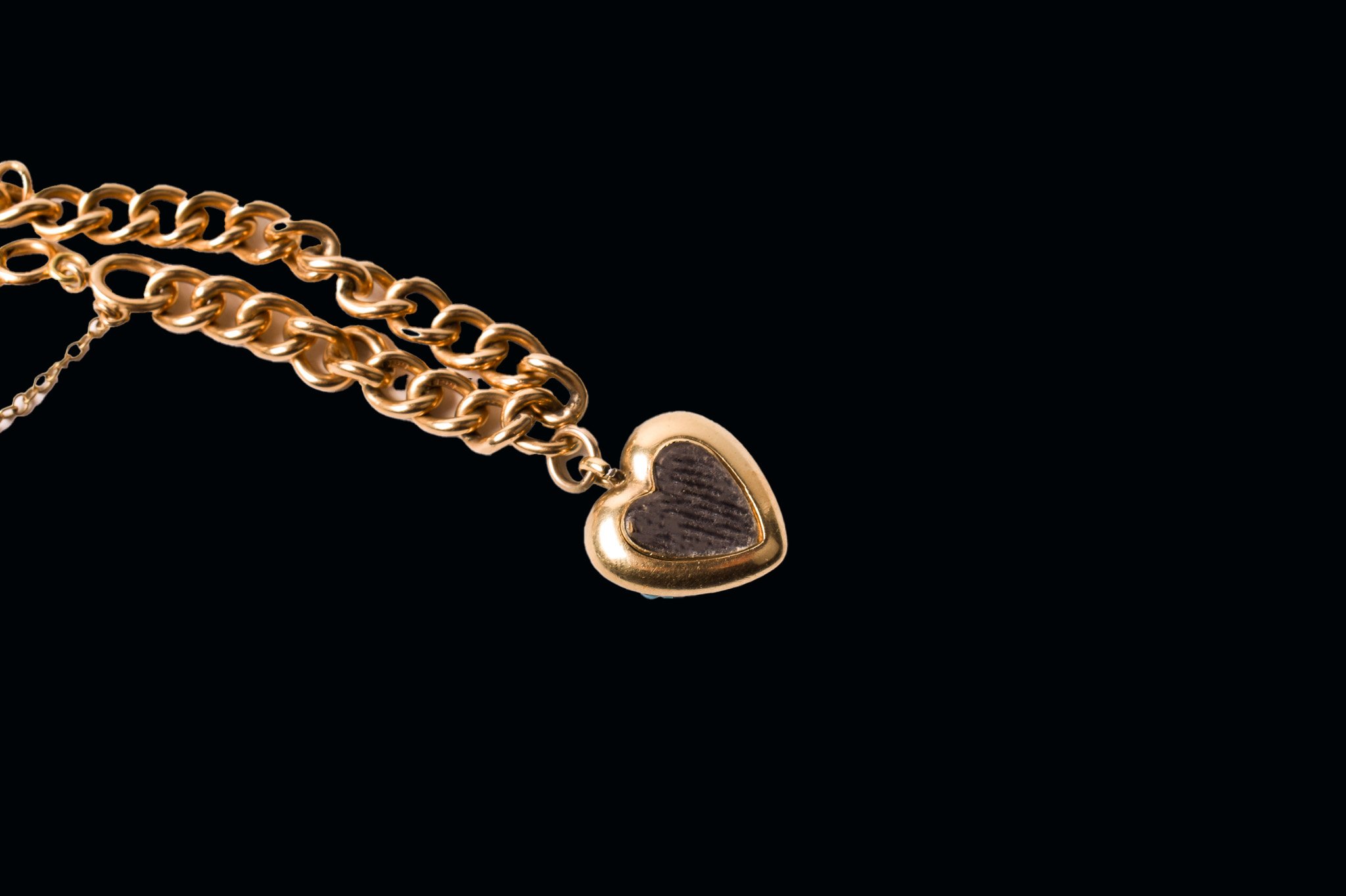Back view of Victorian gold heart locket showing glazed compartment for hair or keepsake