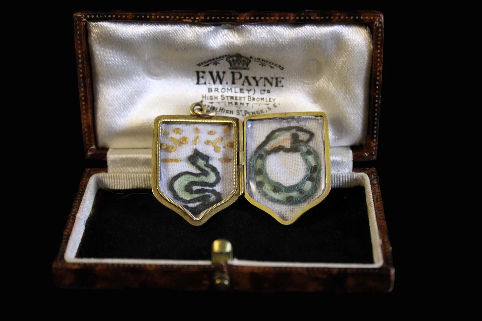 Victorian serpent embroidery.jpg within heraldic shield locket