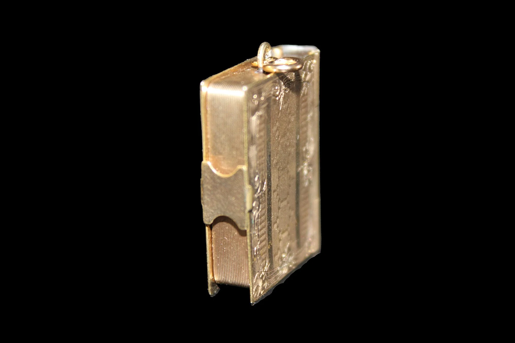 Side view of Victorian 14ct gold book locket showing engraved pages and working clasp.