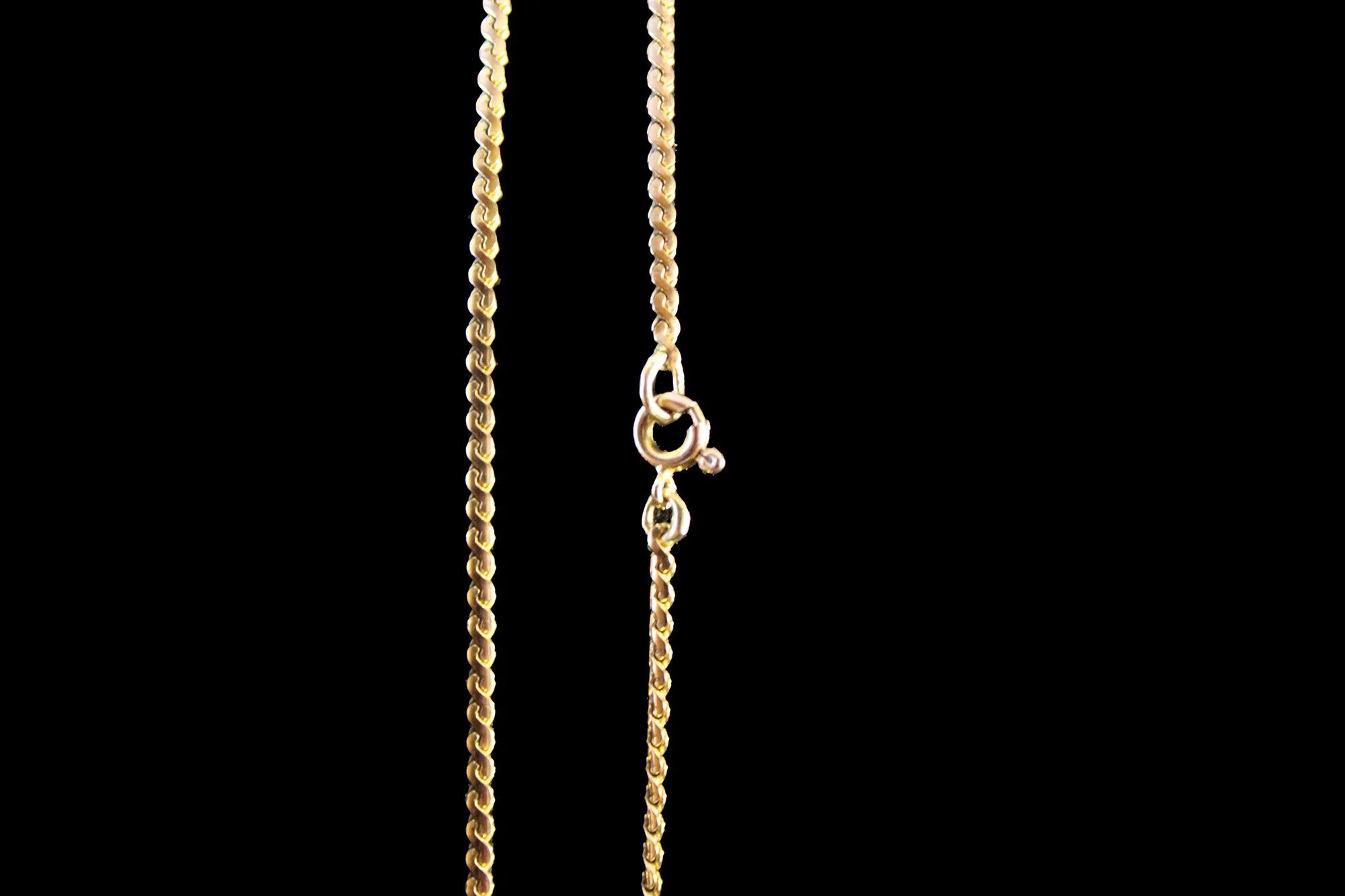 close up spring clasp nine carat gold curb link chain