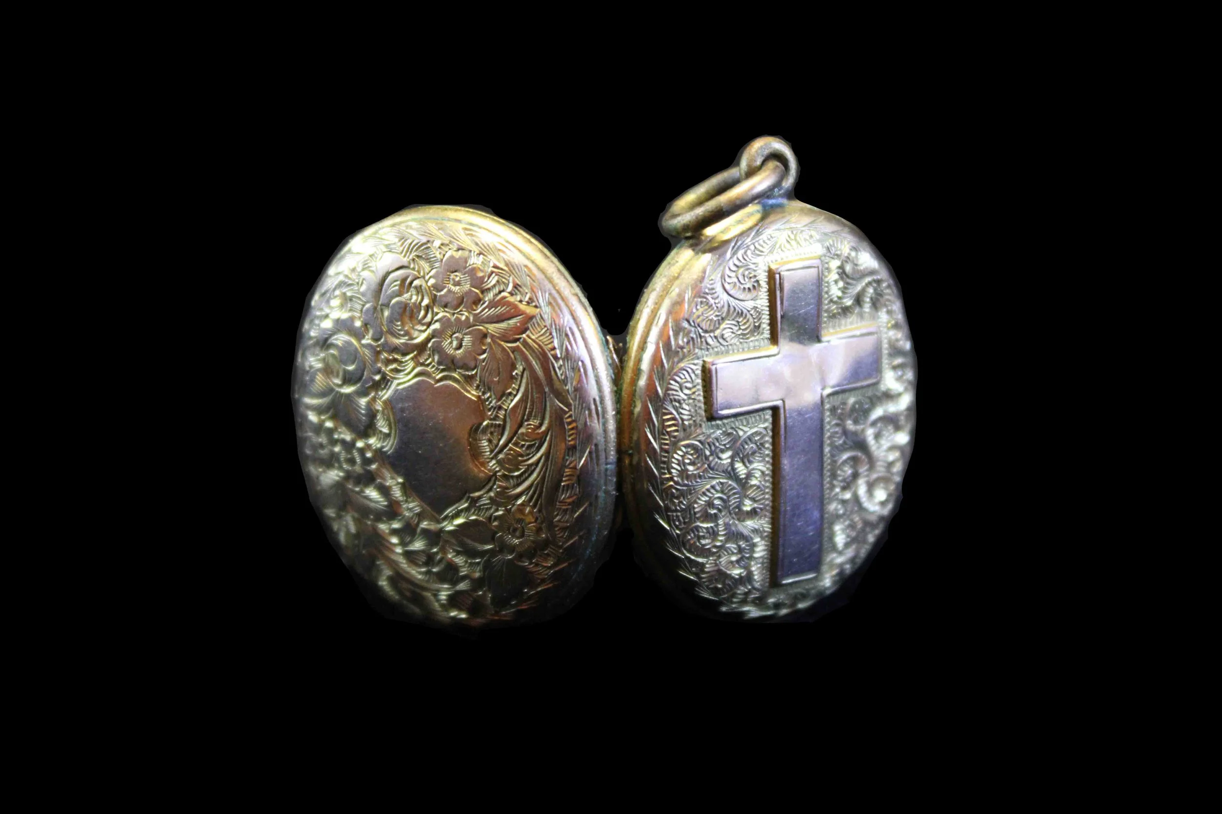 Victorian era gold locket with ornate engraving and religious symbolism, front and back views