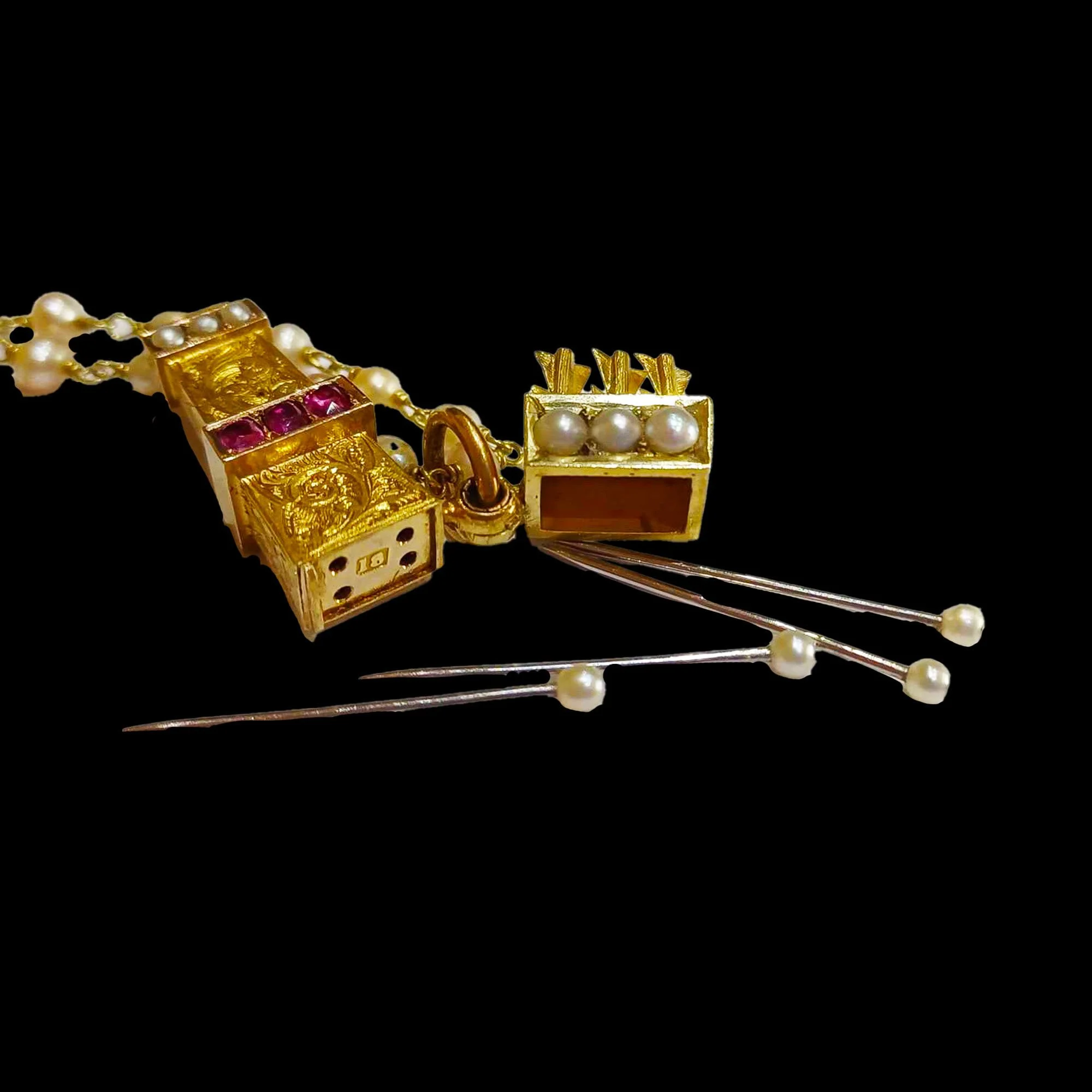 Interior of antique quiver pendant with pearl tipped pins