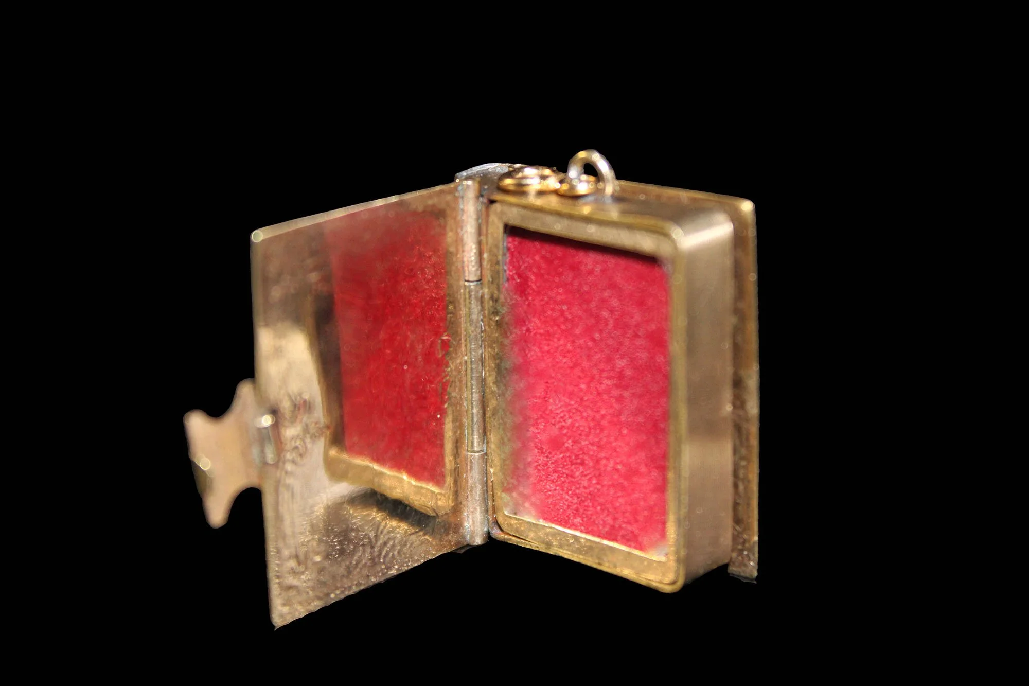 Victorian book locket open showing original photograph glass and velvet-lined interior.