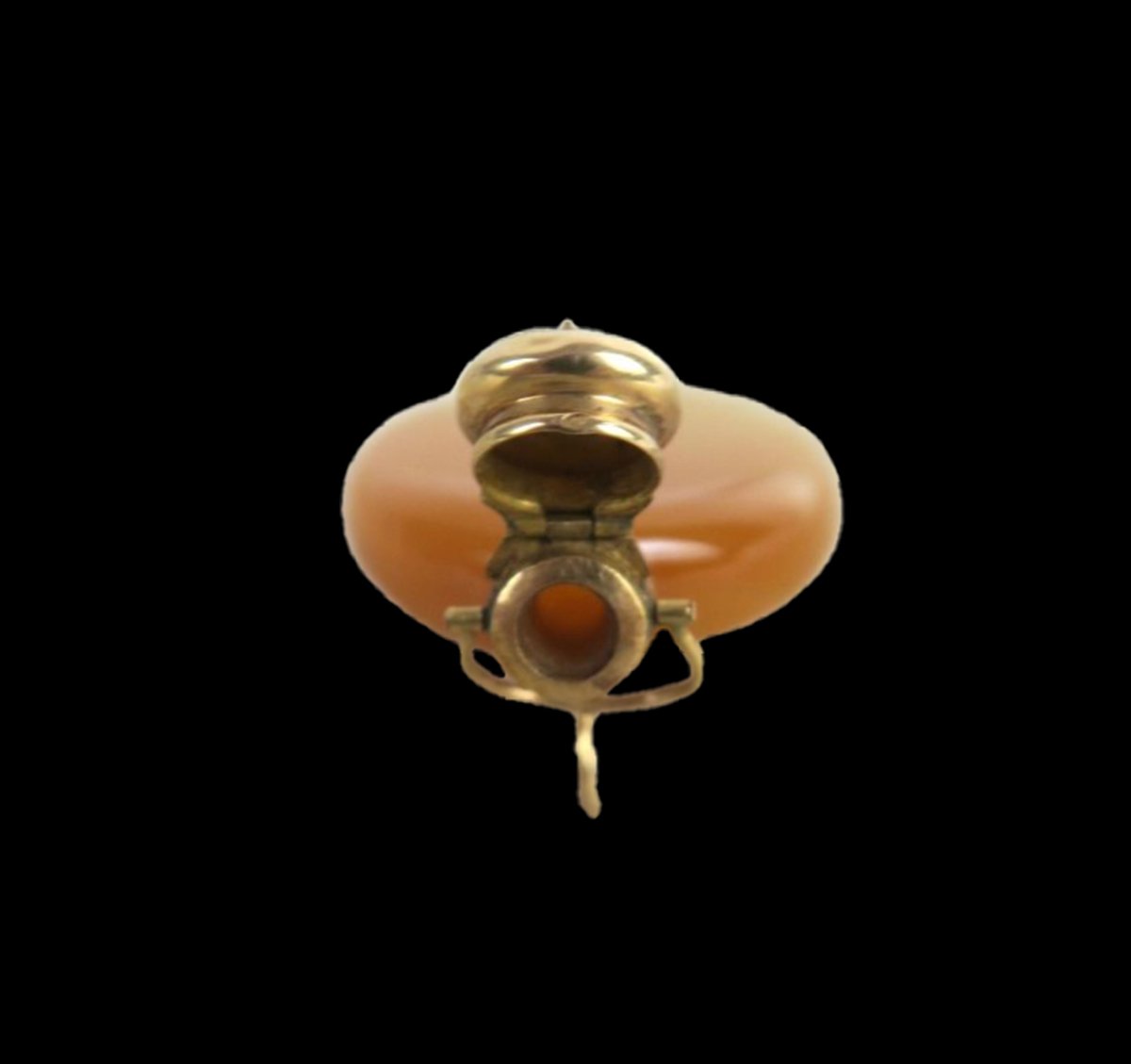 Open hinged gold lid of antique French perfume pendant revealing the circular flask opening and suspension mechanism.