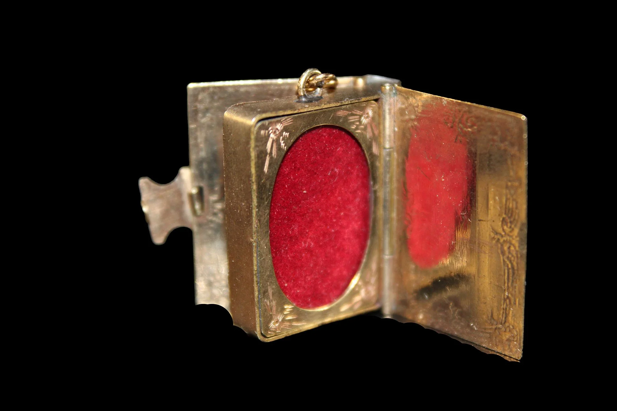 Close-up of Victorian 14ct gold book locket interior with original photo frame and crimson velvet backing.  Product Tags