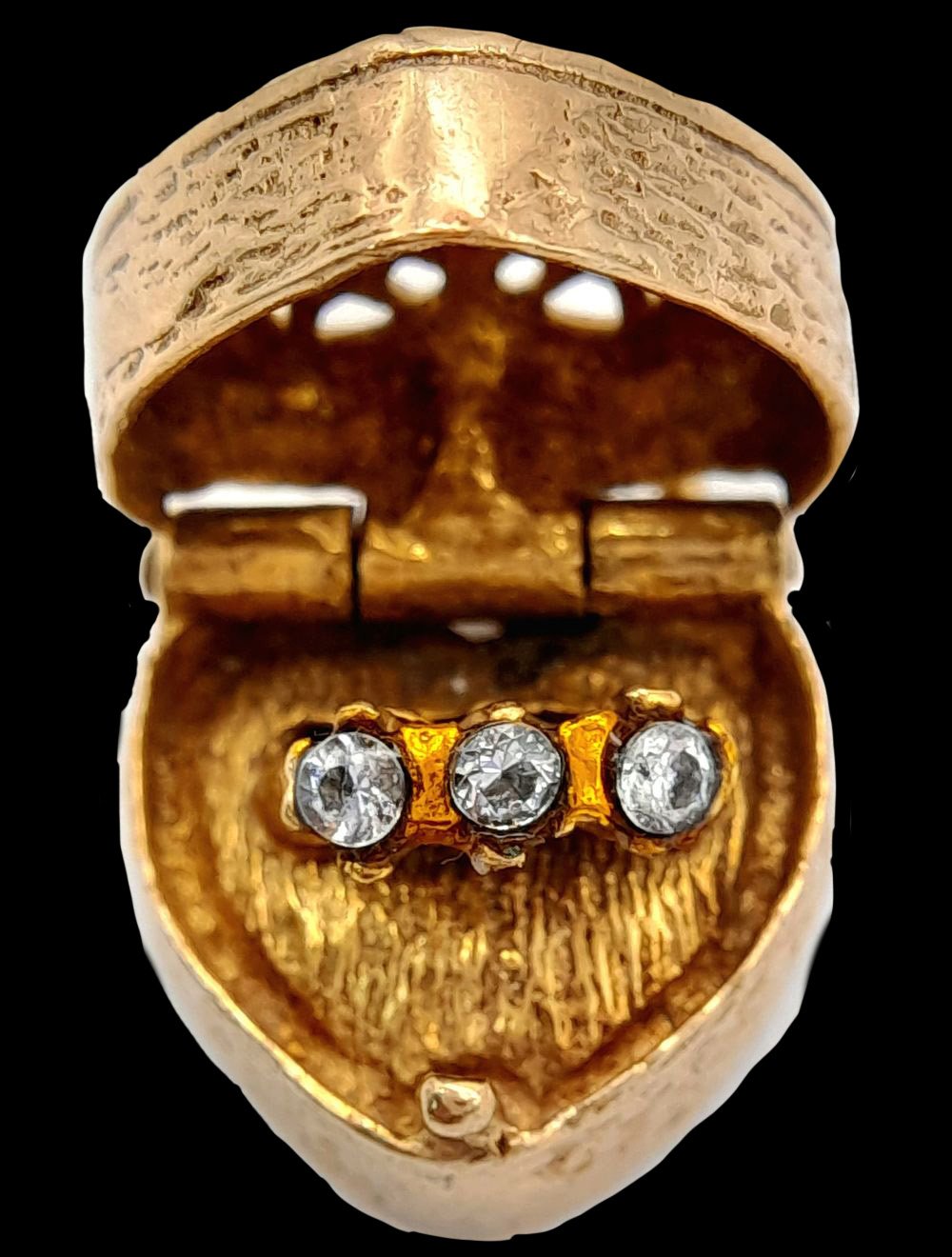 Antique heart locket with three-stone diamond ring motif