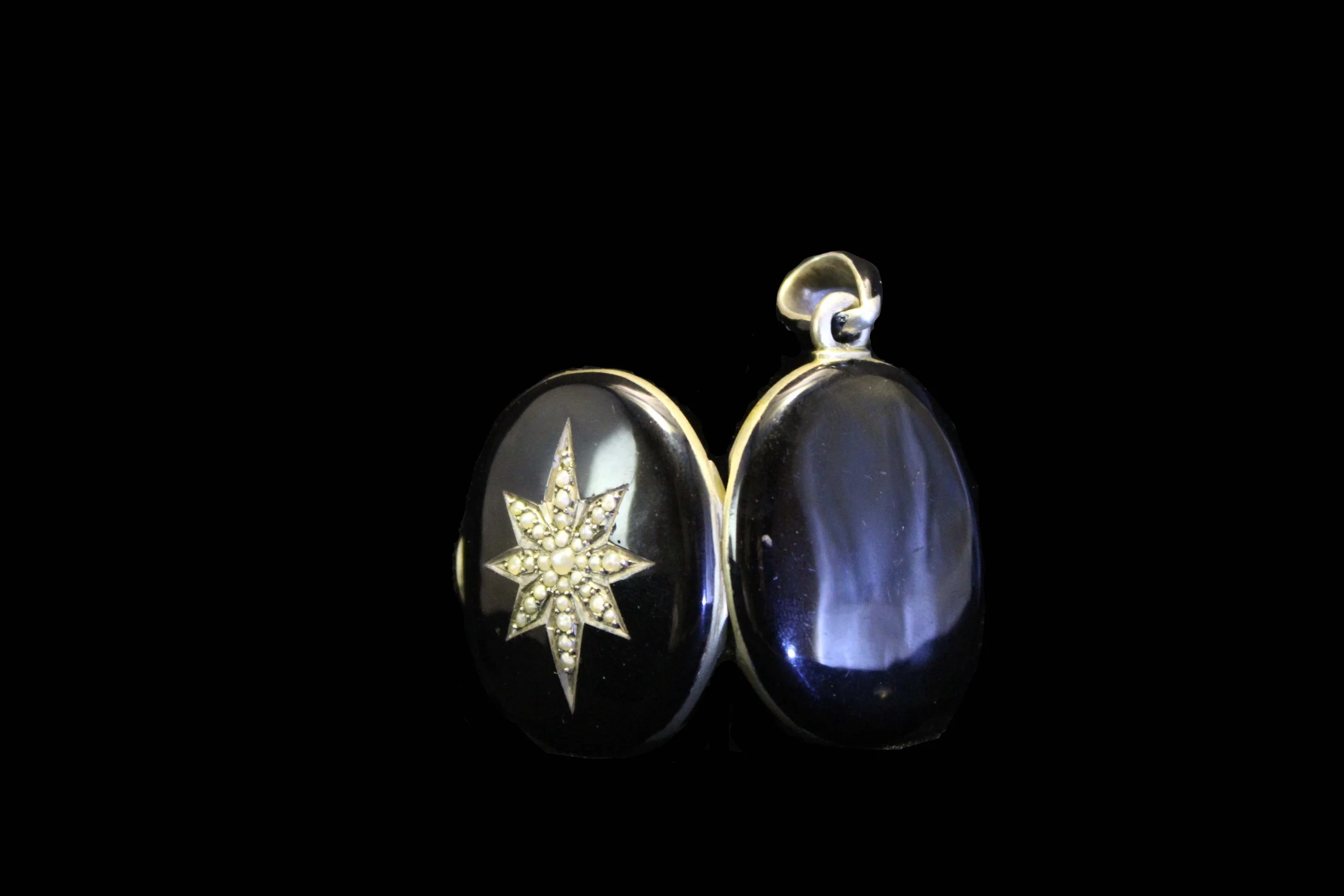 Victorian black onyx star locket shown open, highlighting construction and depth