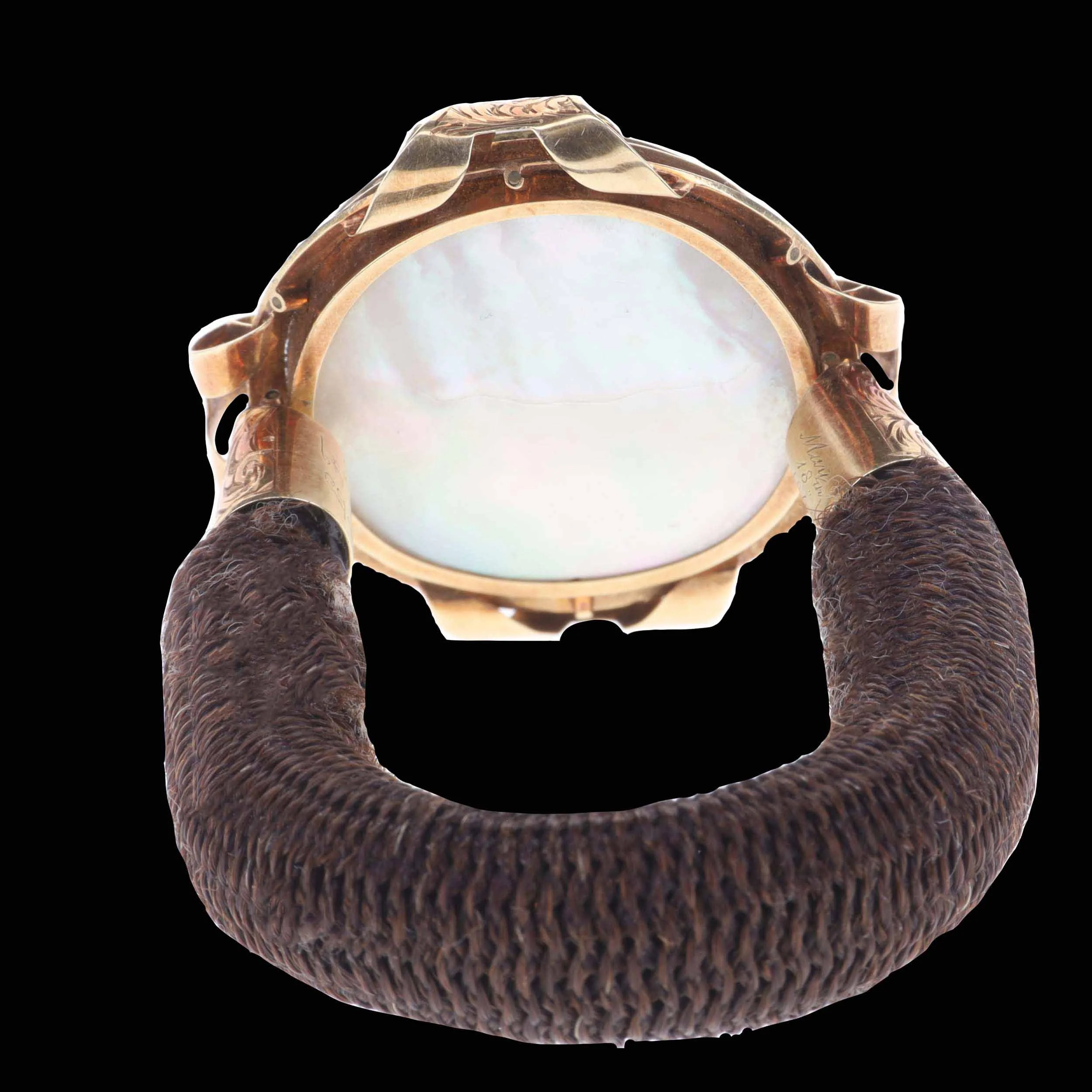 Reverse of Victorian hairwork bracelet showing mother-of-pearl locket backing
