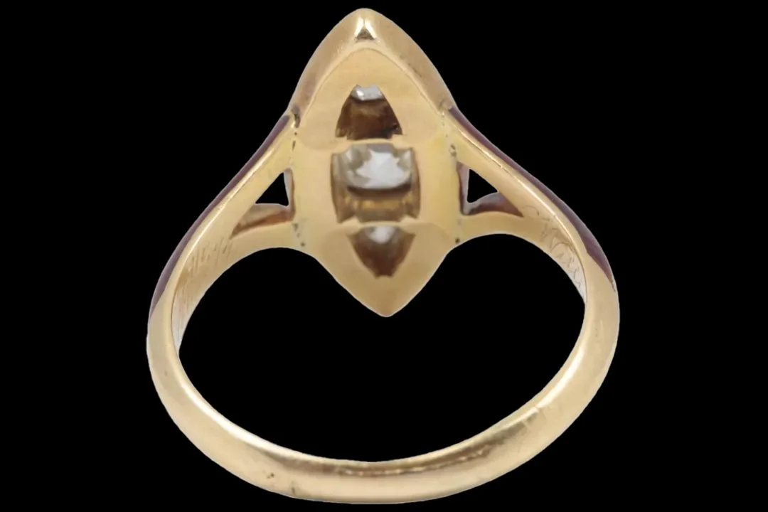 Underside of Victorian gold diamond mourning ring showing open-backed diamond settings, pierced split shoulders, and gold band construction.