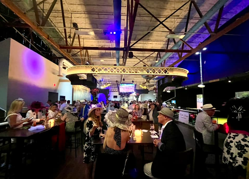 Guests dressed in Kentucky Derby attire enjoying a themed event at Back 9 Social in Wallingford, CT