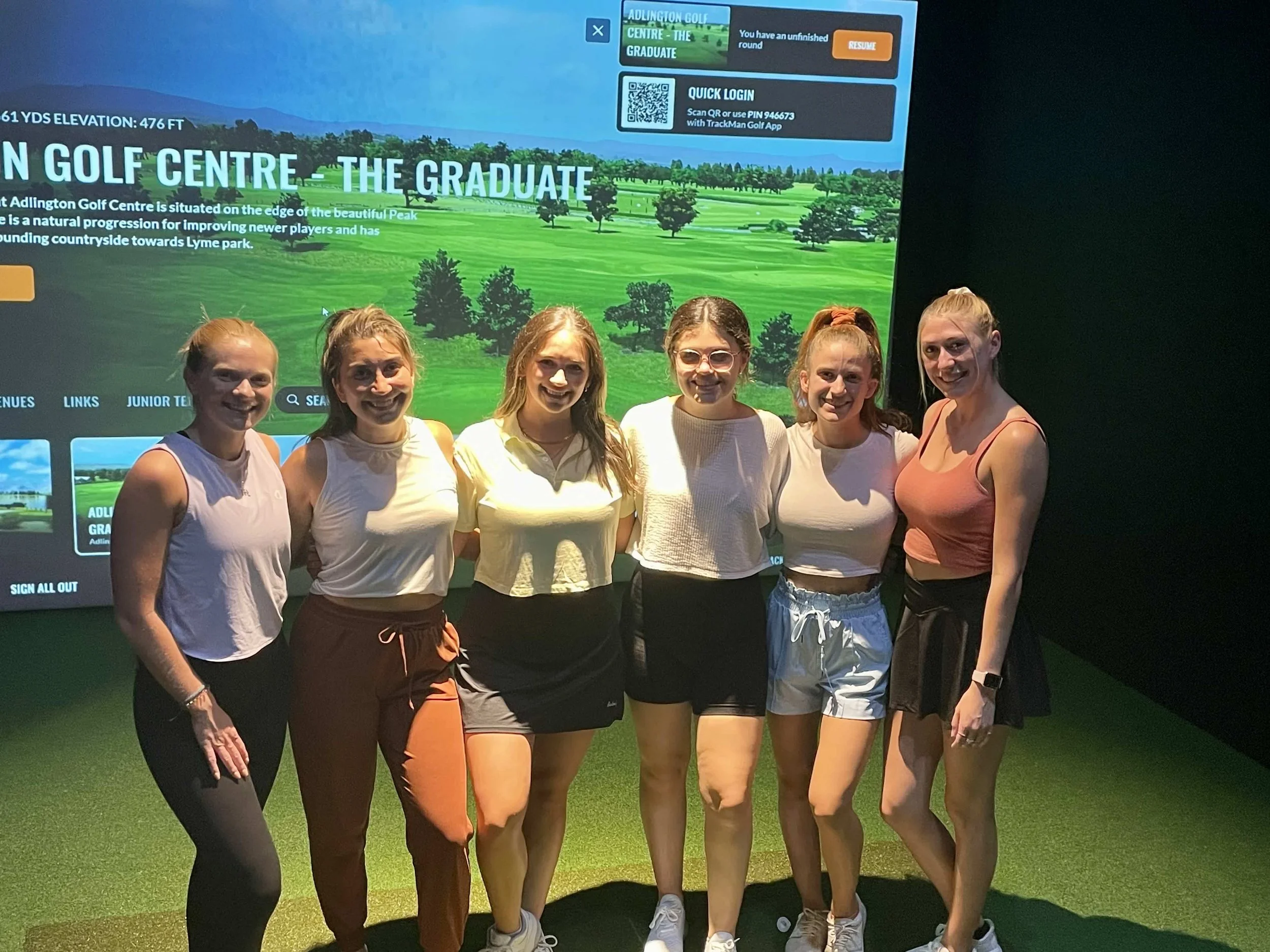 Group of women smiling in a Trackman golf simulator bay at Back 9 Social in Wallingford, CT