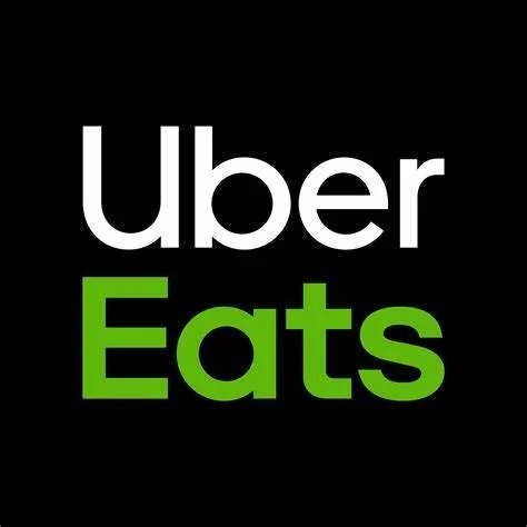 Uber Eats logo with white and green text on a black background.