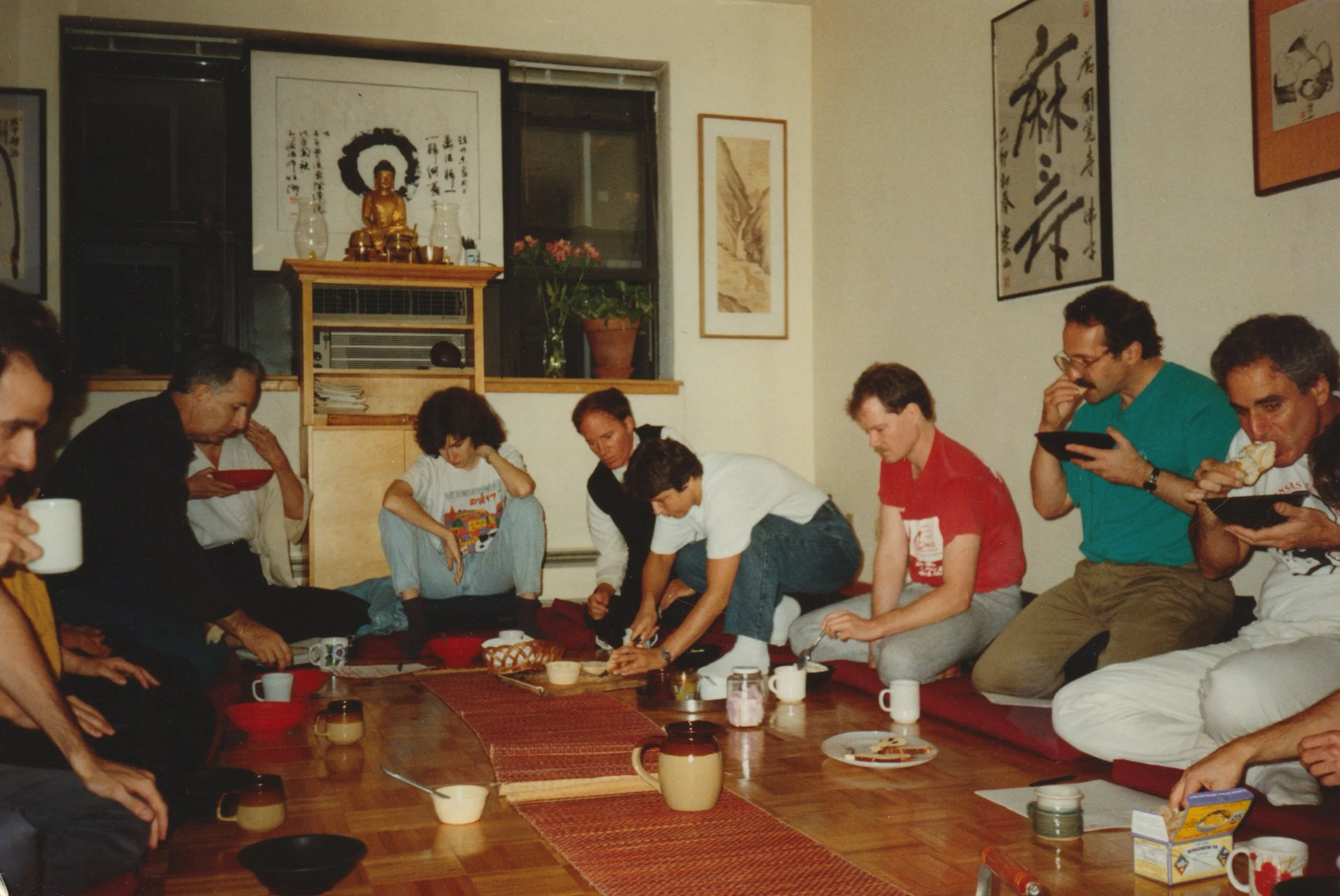Practitioners gathered informally around the altar area at 400 East 14th Street, 1992, sharing a meal after practice.