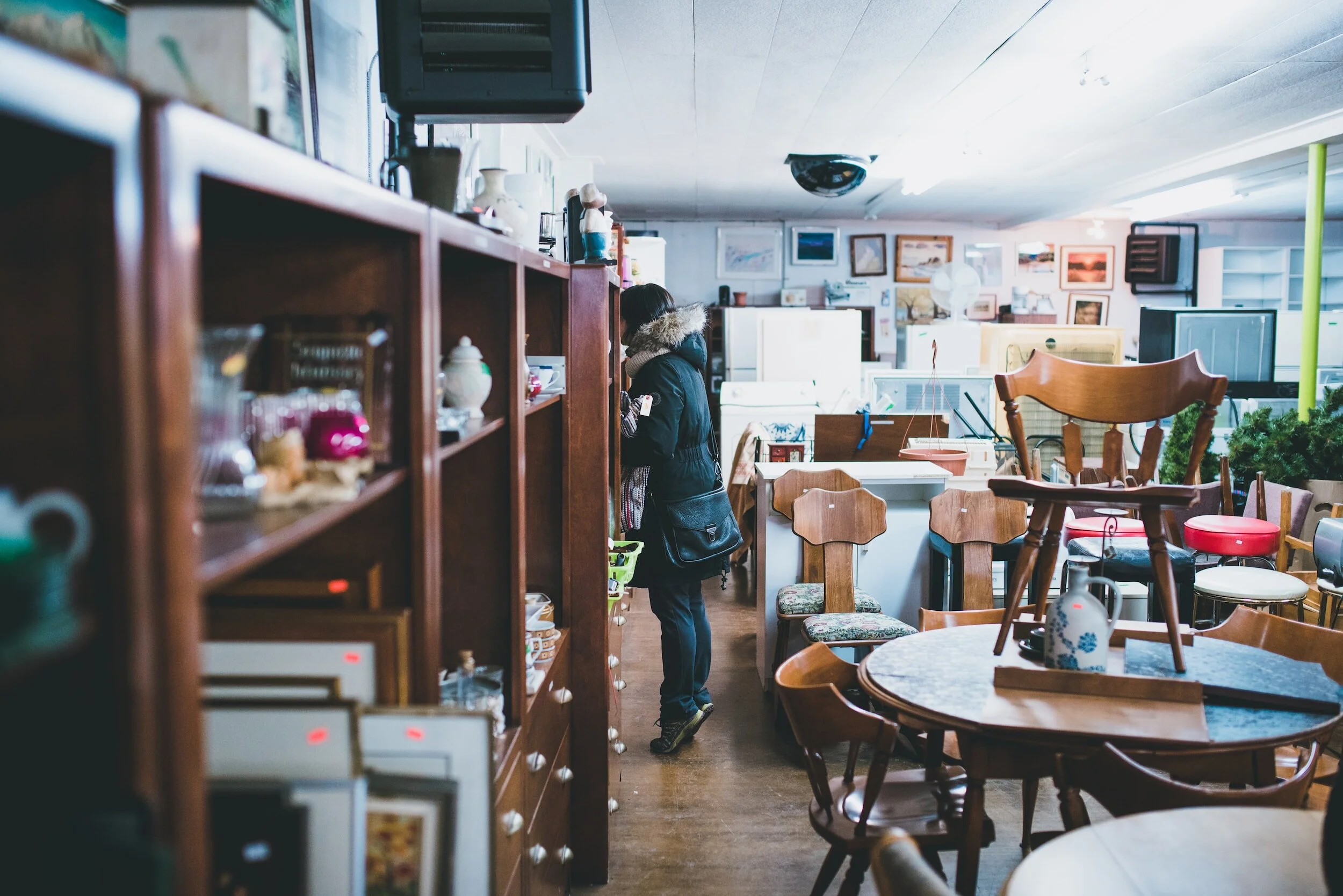 woman shopping in a vintage second-hand furniture store