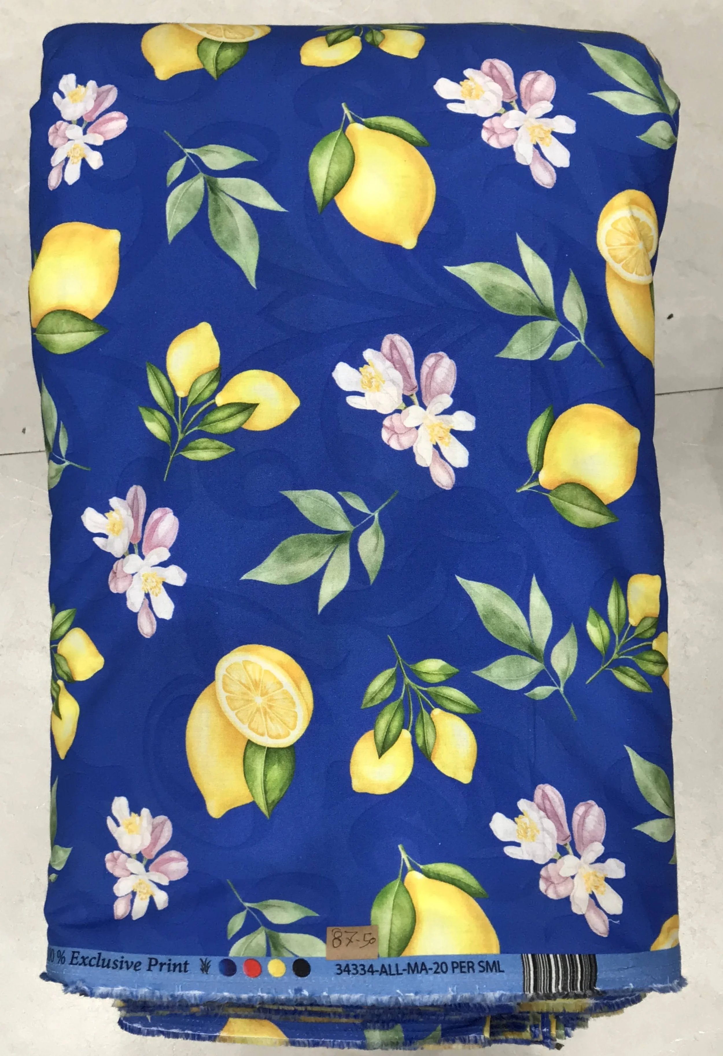 Deep navy blue background featuring a vivid tropical fruit print with bright yellow lemons, white blossoms, and lush green foliage.