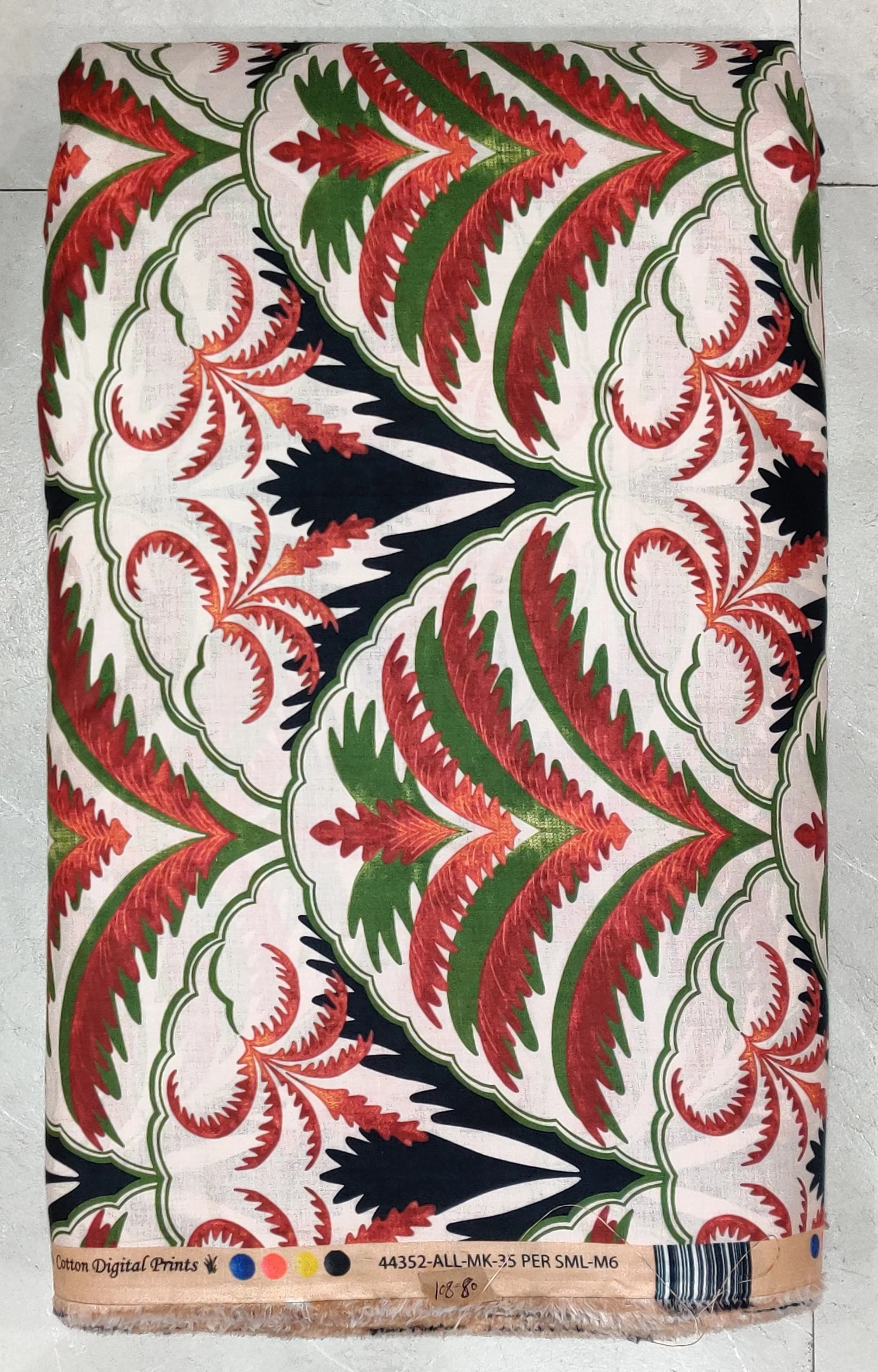 Vibrant coral pink and emerald green tropical botanical print featuring lush foliage, perfect for breezy resort wear.