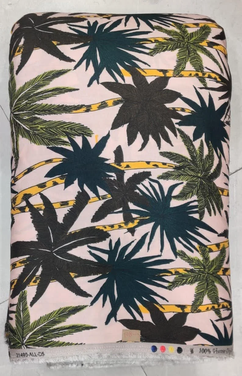 Luminous blush-pink and deep charcoal-grey textile showcasing a botanical silhouette pattern featuring scattered palm fronds, delicate branching stems, and soft muted tonal contrasts.