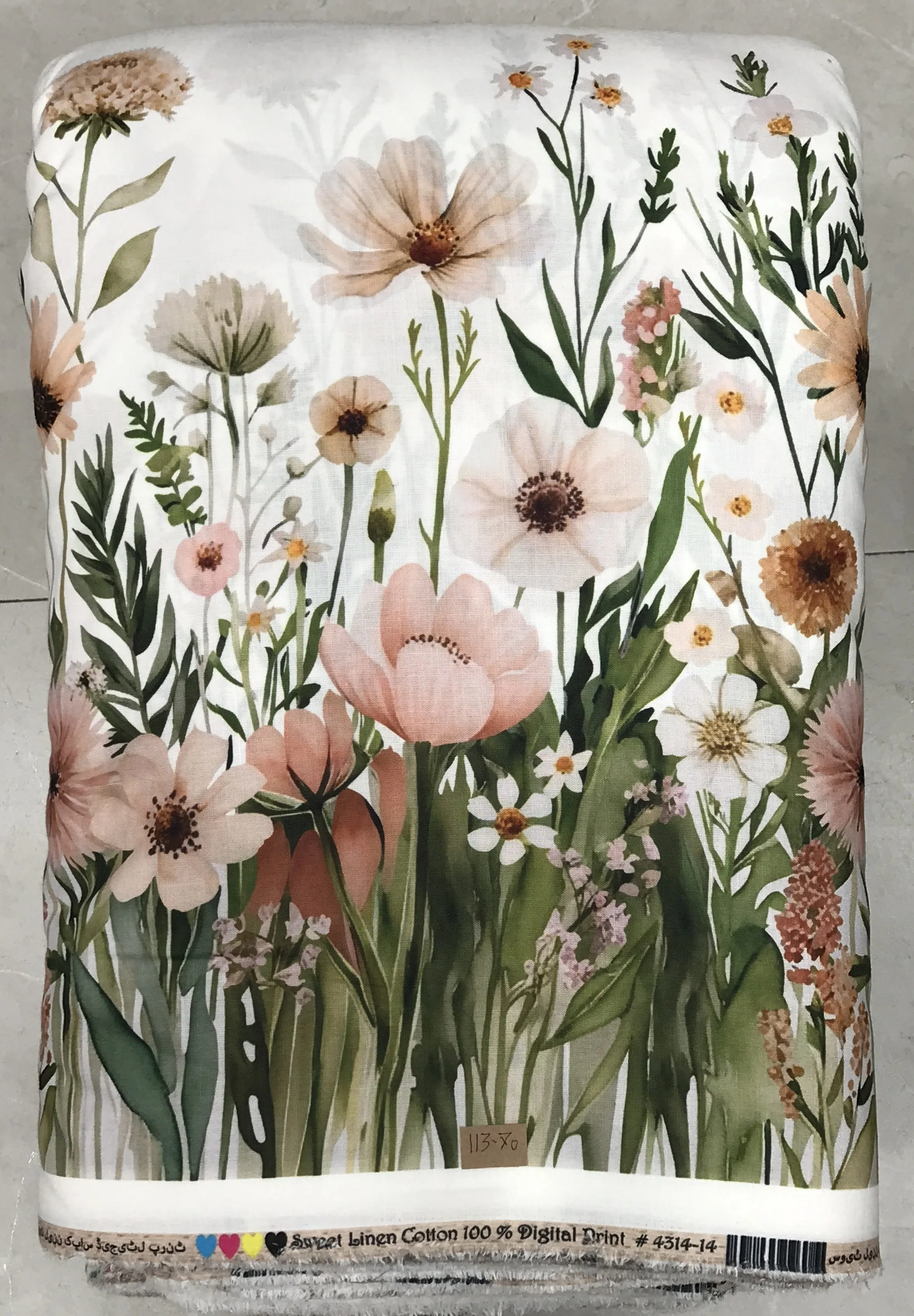 Soft blush-pink, sage-green, and cream fabric featuring a charming all-over botanical print with delicate blooming wildflowers, slender leafy stems, and a gentle watercolor effect.