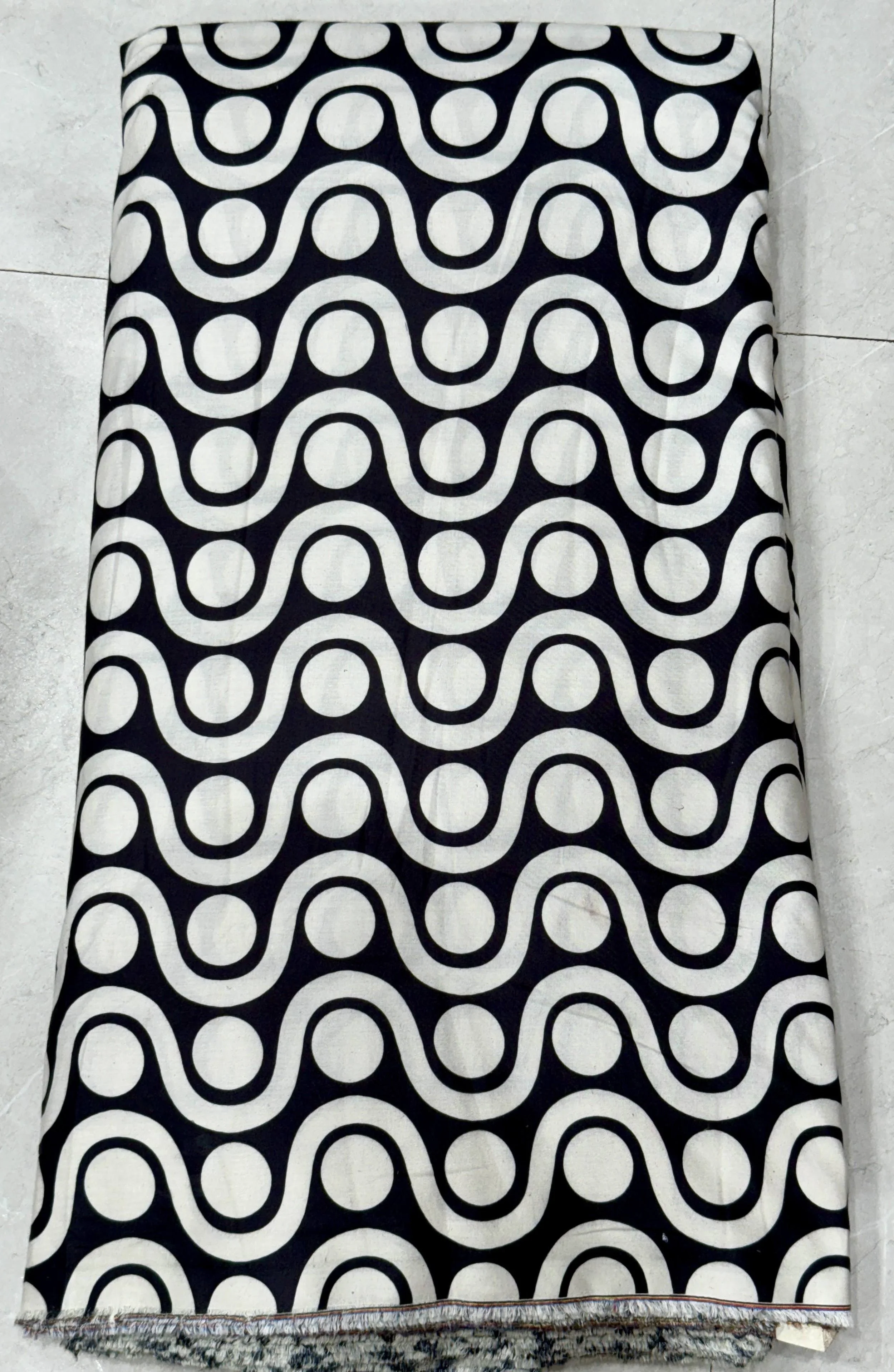 Classic monochrome fabric featuring a bold, interlocking geometric wave pattern in striking black and white.
