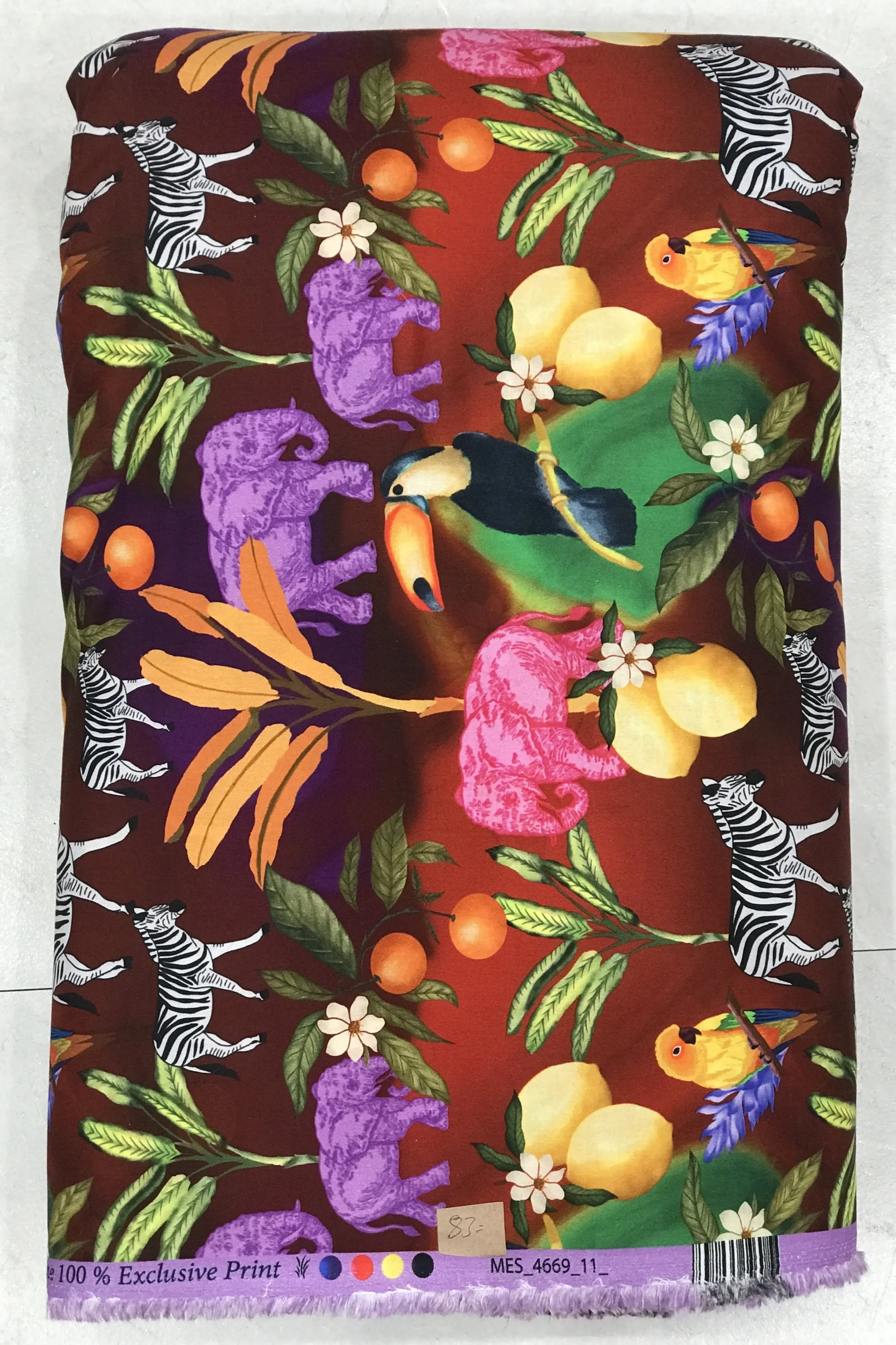 Rich deep burgundy or rust-red background featuring an exotic tropical safari print with vibrant green palm leaves, colorful toucans, hidden tigers, and striking citrus fruits.